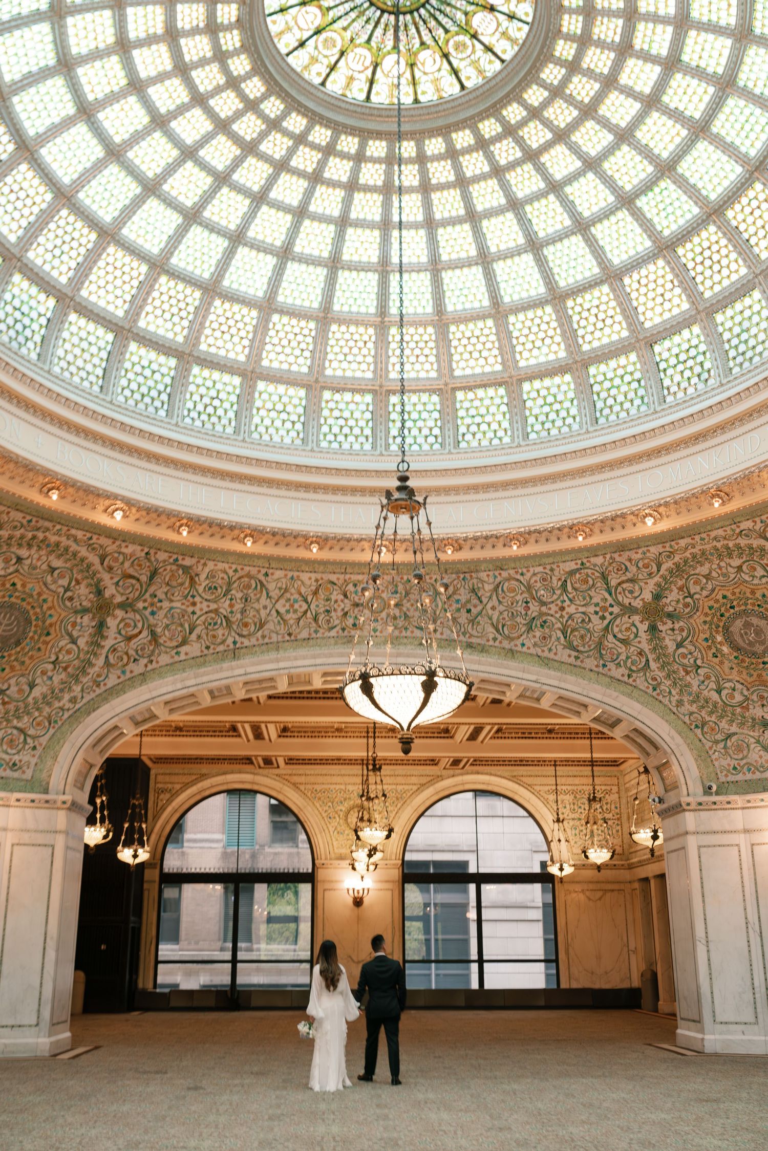 A stunning domed interior with ornate architectural details and a glass ceiling in the Chicago Cultural Center.