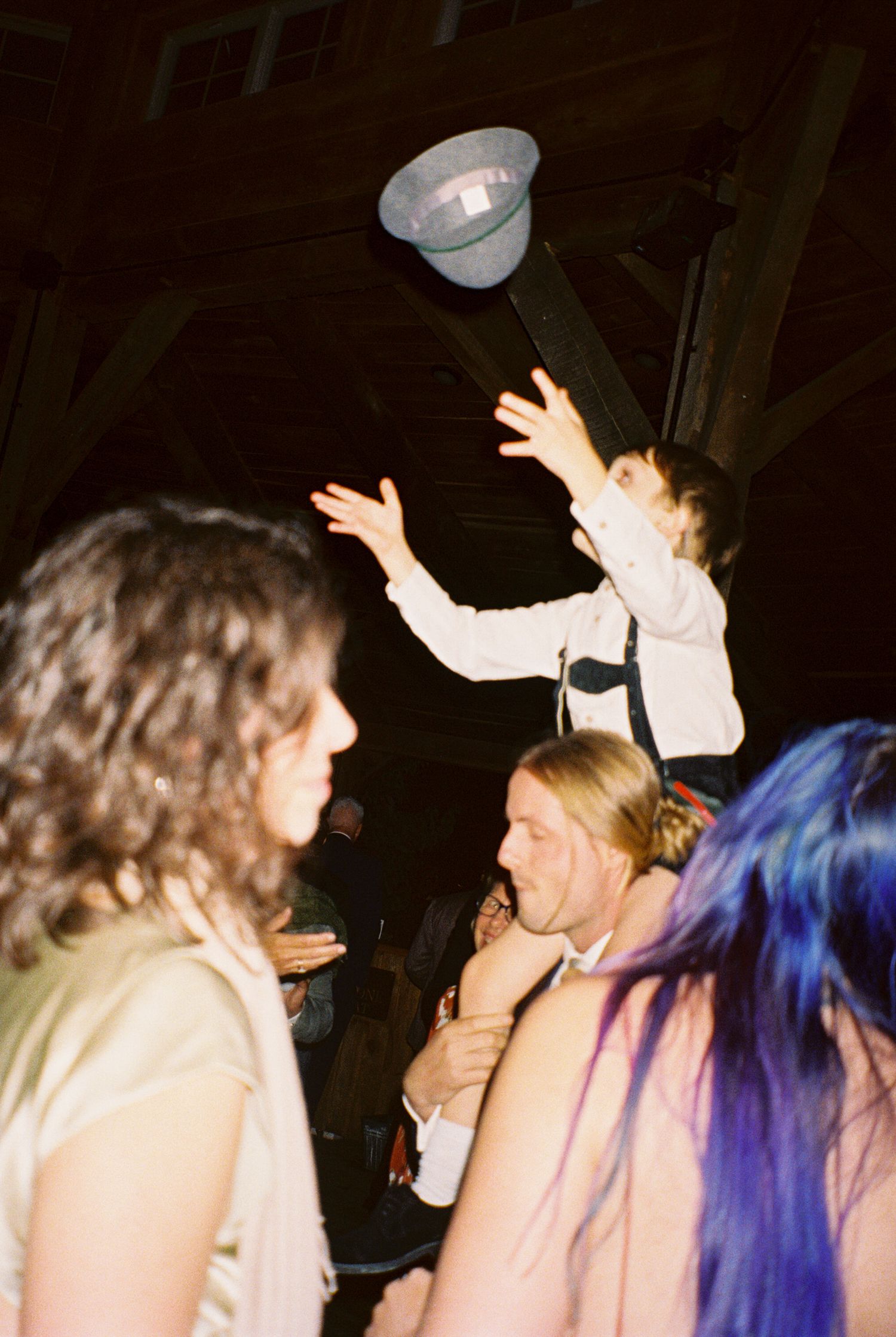 A sequence of candid party photos showing people dancing and interacting in a dimly lit setting with animated expressions.