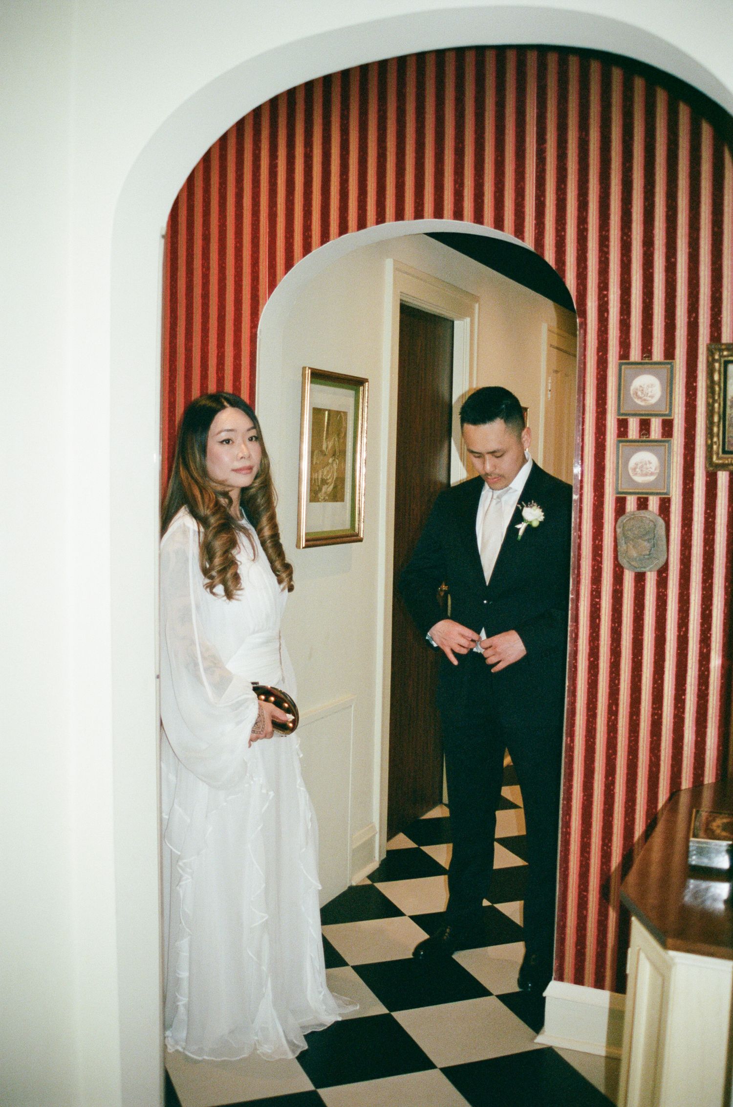 A sequence of wedding photos showing a couple in formal attire walking through a doorway with striped wallpaper.