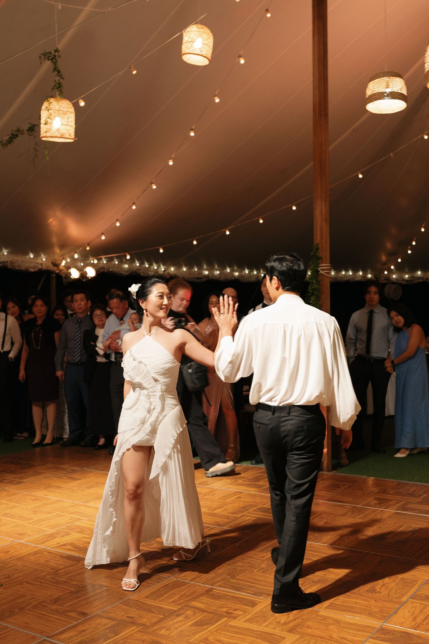 A sequence of dance photos shows couples spinning and twirling on a wooden dance floor under a tent with hanging lights.