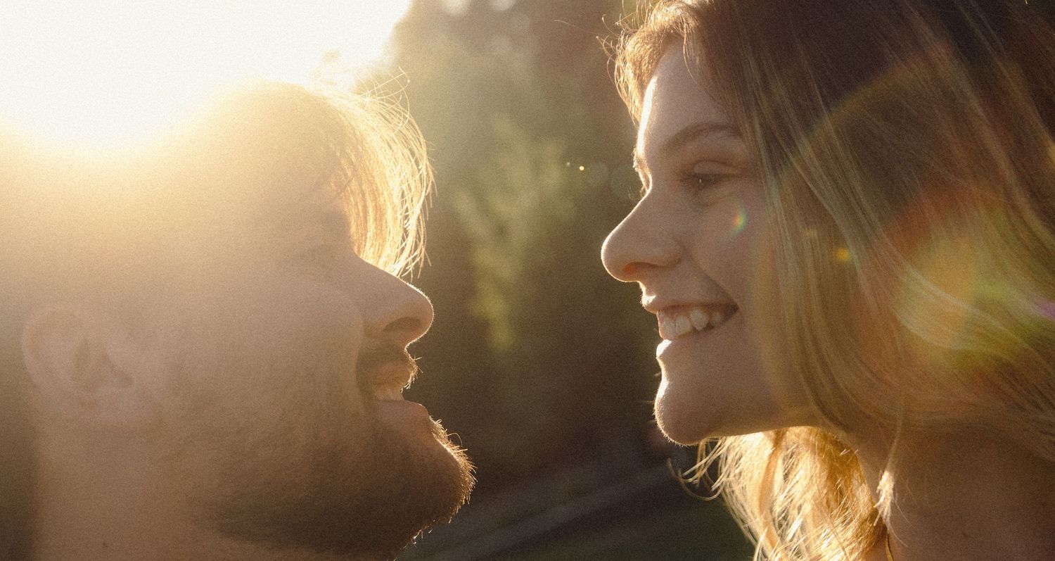 Six silhouetted close-up profiles illuminated by warm golden sunlight create a dreamy panoramic view.