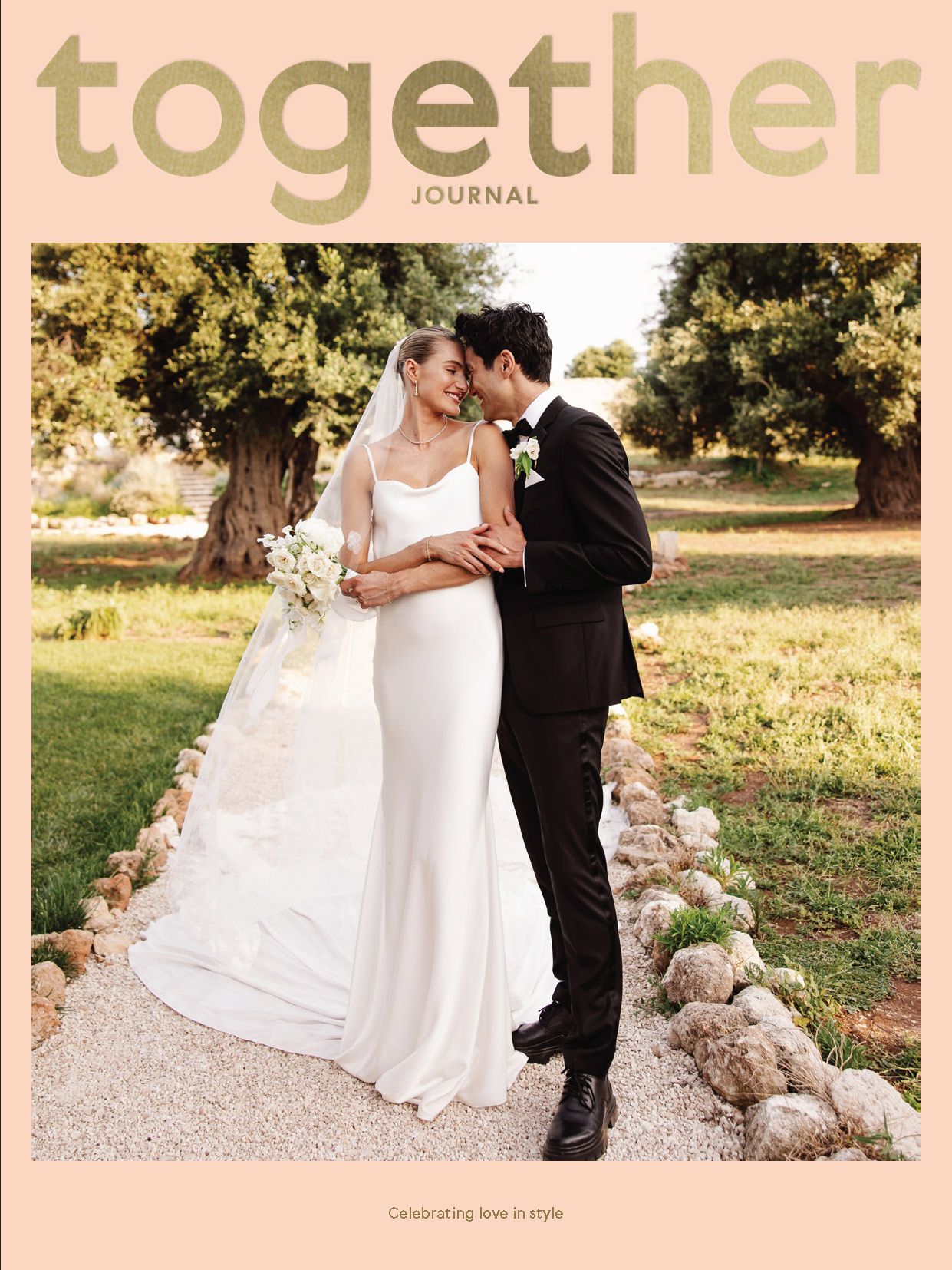 A romantic wedding magazine cover shows a couple sharing an intimate moment on a stone path with natural sunlight.