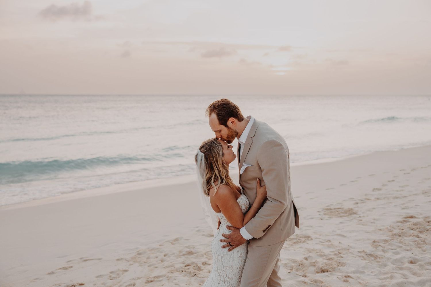 Aruba wedding couple walking along Eagle Beach at sunset