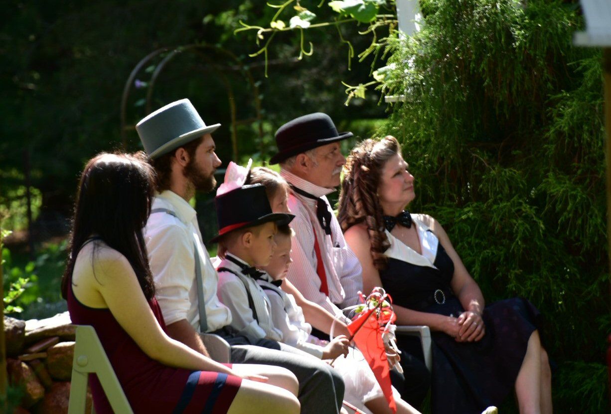 Family watching wedding ceremony during an intimate backyard wedding in Niagara