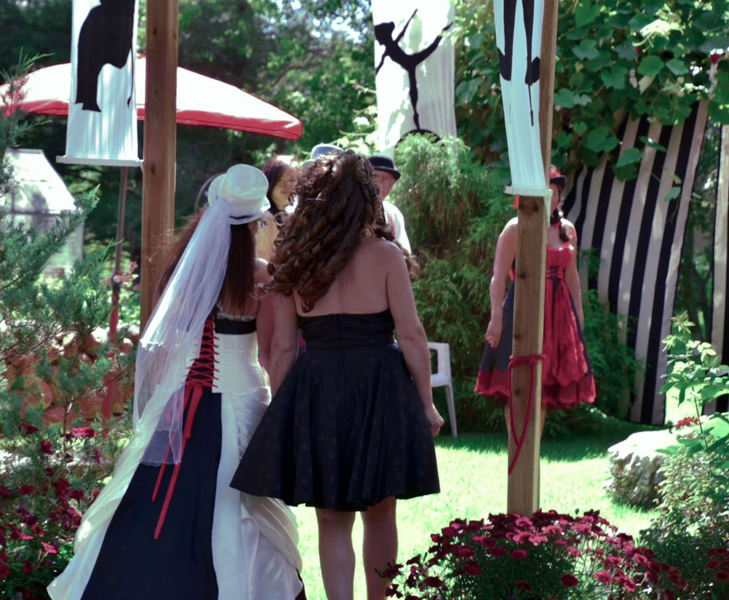 Bride and her mother walk down the isle at a circus themed intimate backyard wedding at their home in Niagara.