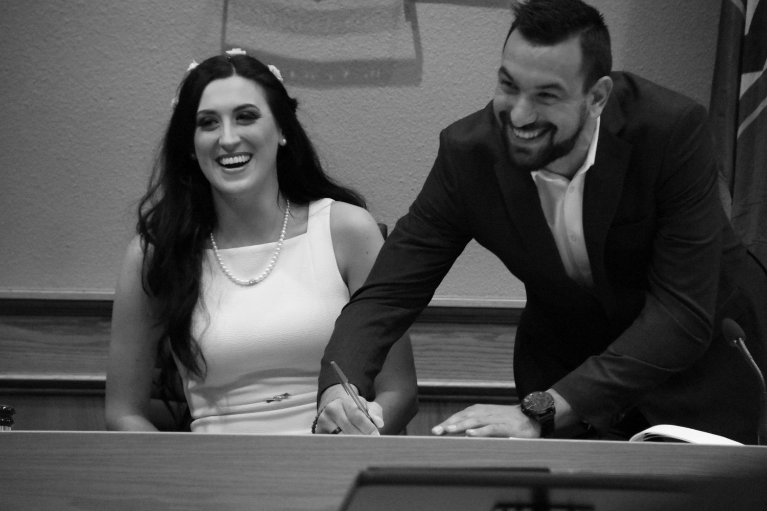 Bride and groom signing marriage license in Council Chambers at Niagara Falls City Hall