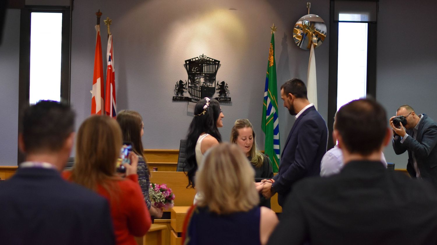 Family and friends look on during wedding ceremony at Niagara Falls City Hall
