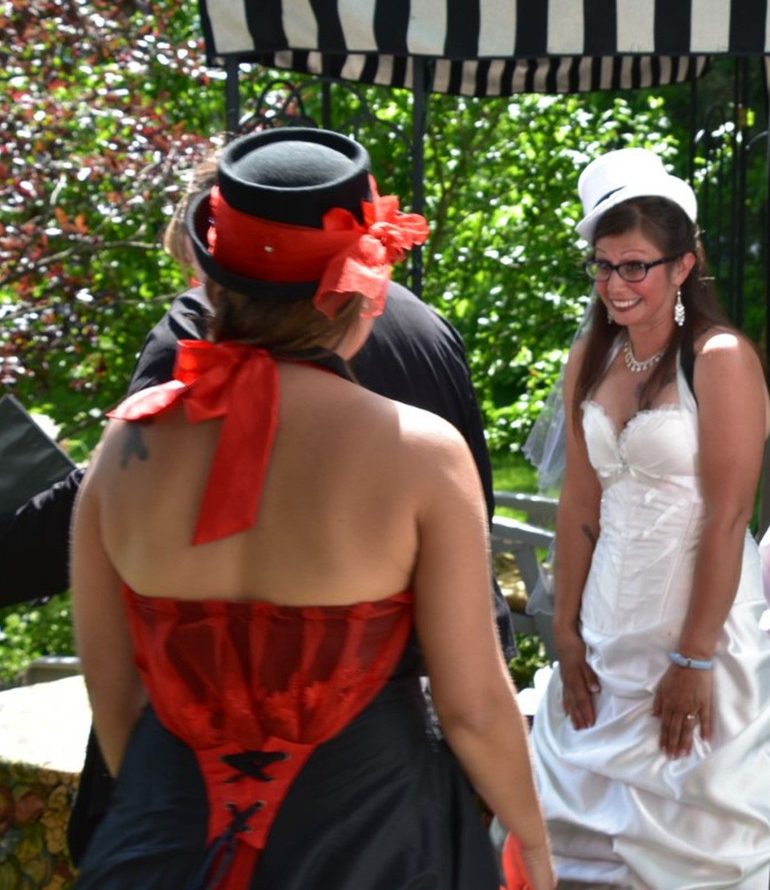 Bride and bridesmaid sharing a moment before intimate backyard wedding ceremony