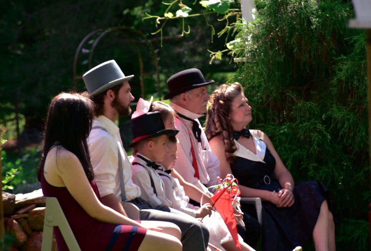 Family looks on at an intimate backyard wedding in Niagara.
