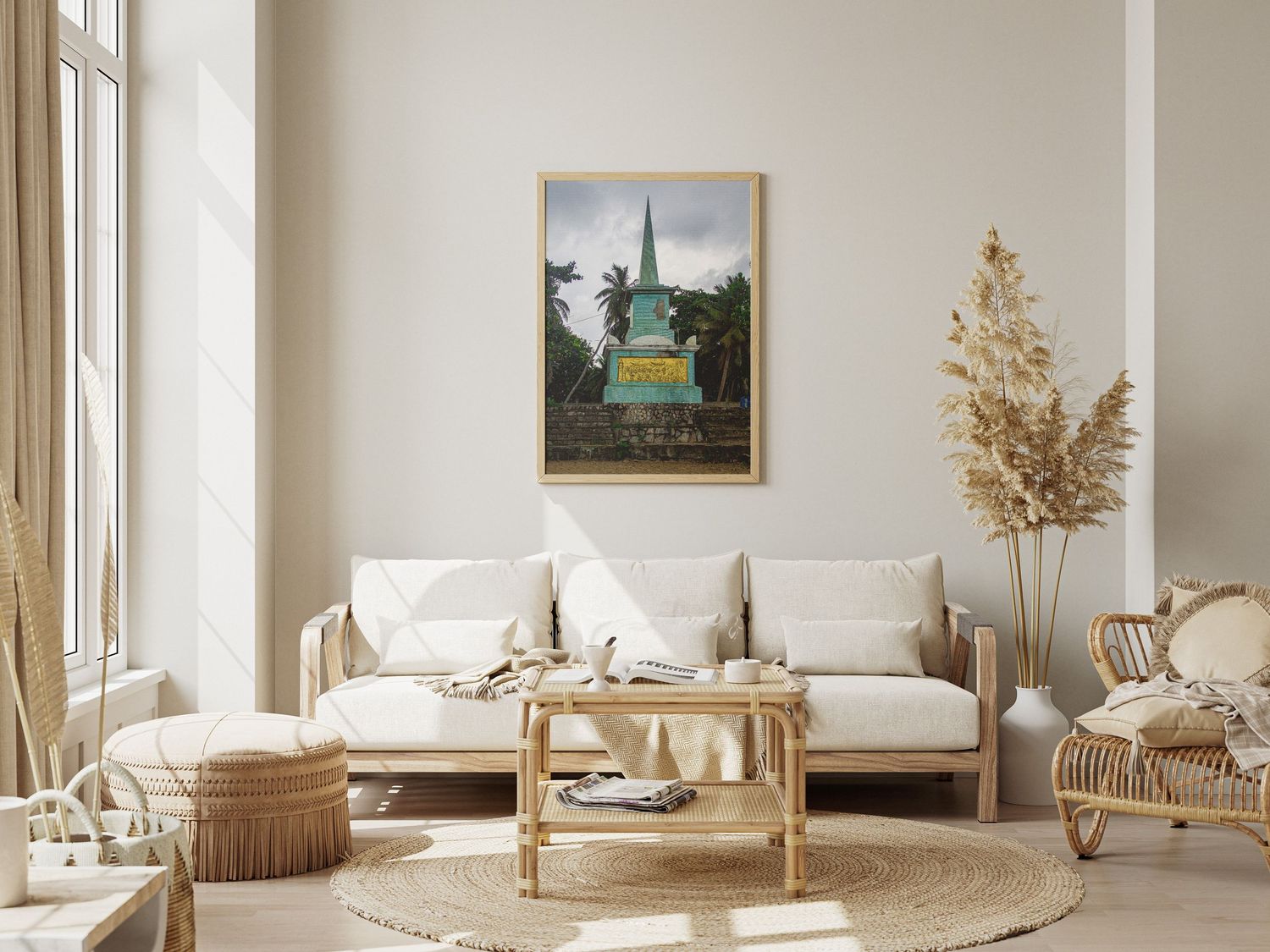 Framed photo of the Statue of Liberty in a gold frame above a white sofa in a bright bohemian living room.