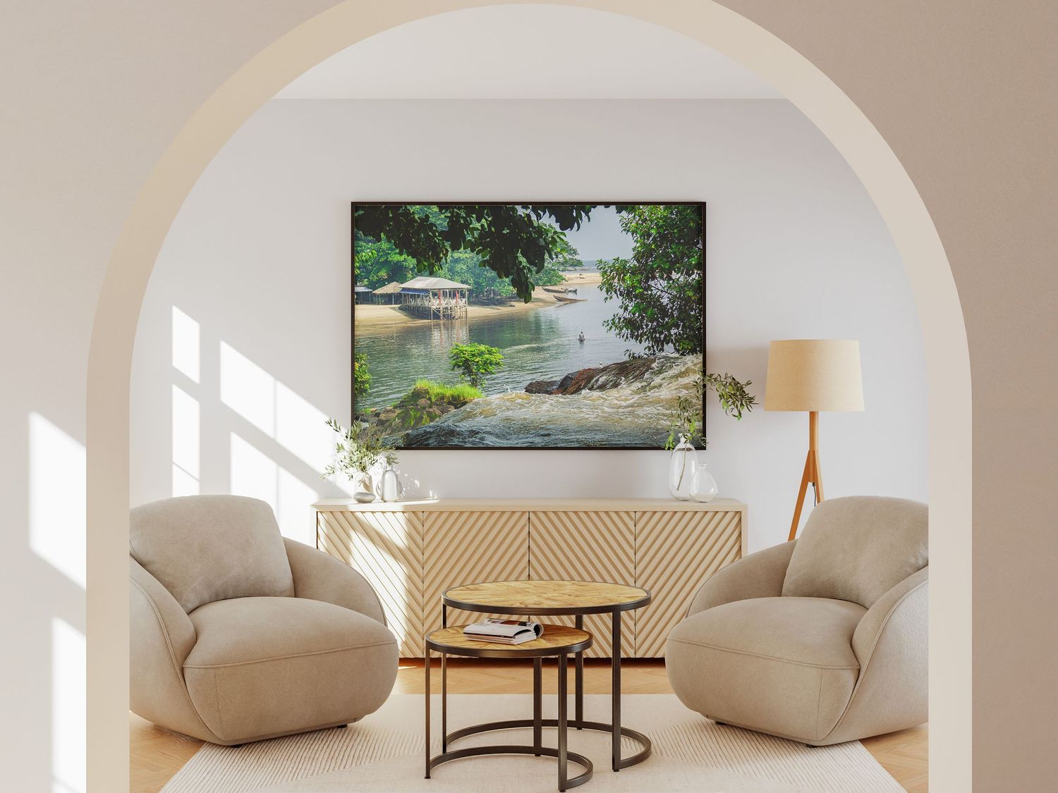 Large framed landscape painting of a serene riverside scene displayed in a bright arched living room.