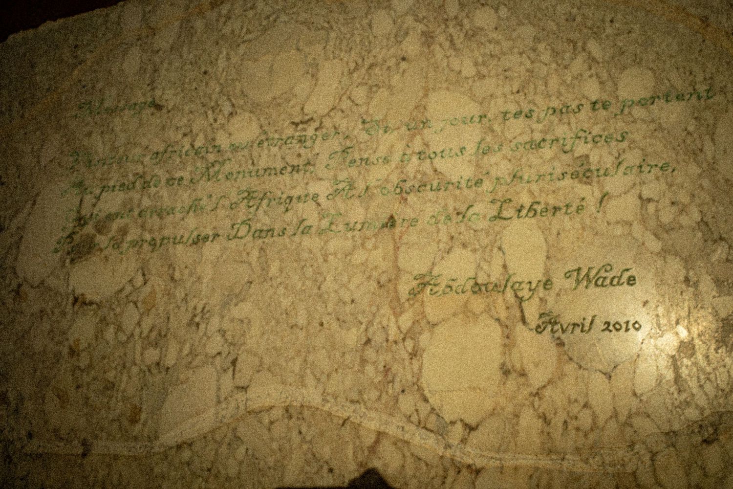Handwritten inscription on marble stone signed by Abdoulaye Wade dated April 2010 in French.