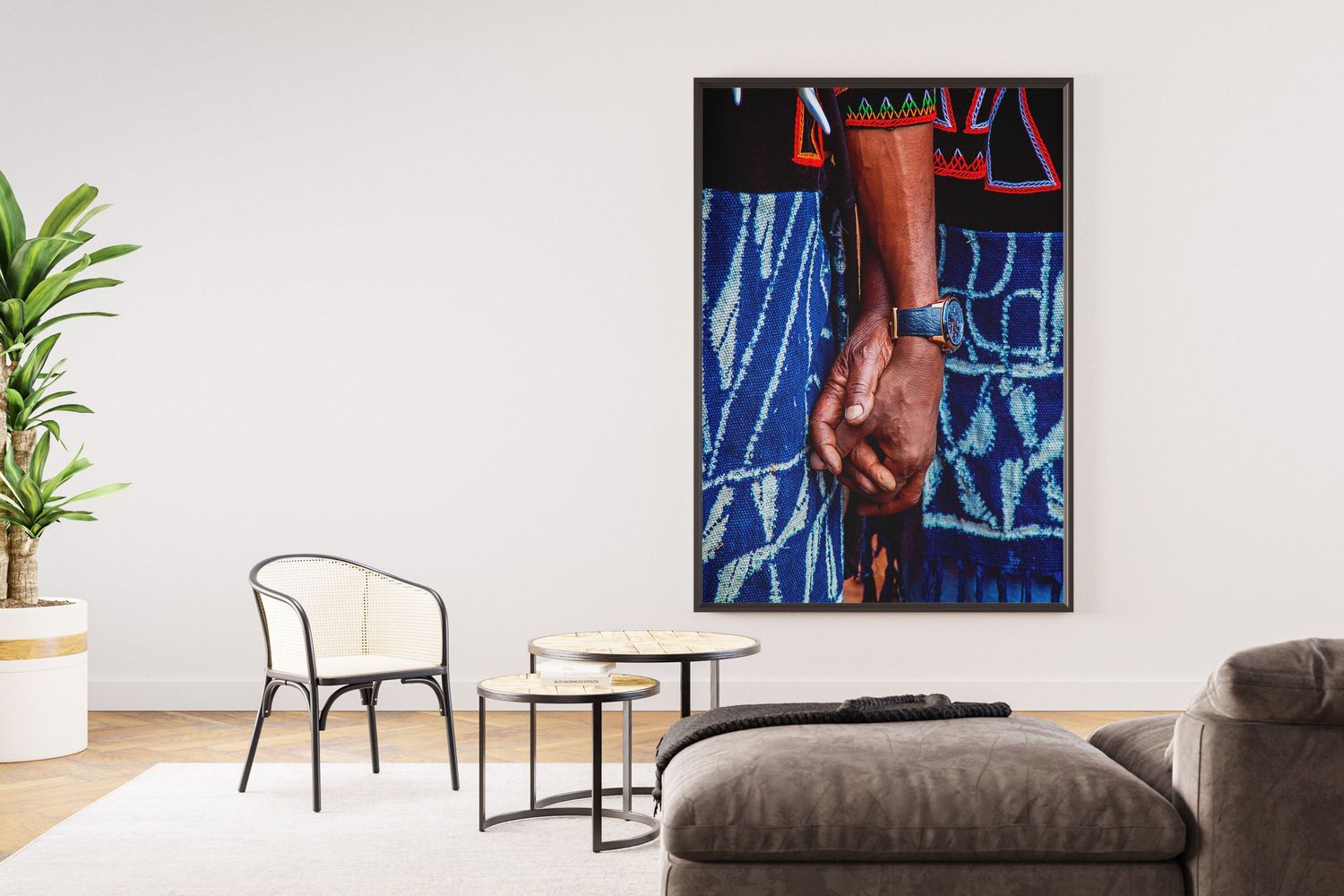 Close-up framed photo of a person's hand wearing a watch against vibrant blue fabric, displayed in modern living room.