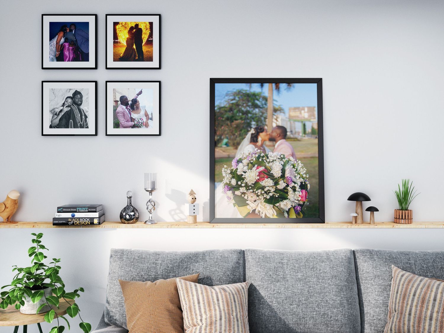 Wedding photo wall art collection with couple kissing displayed above a gray sofa in a modern living room.