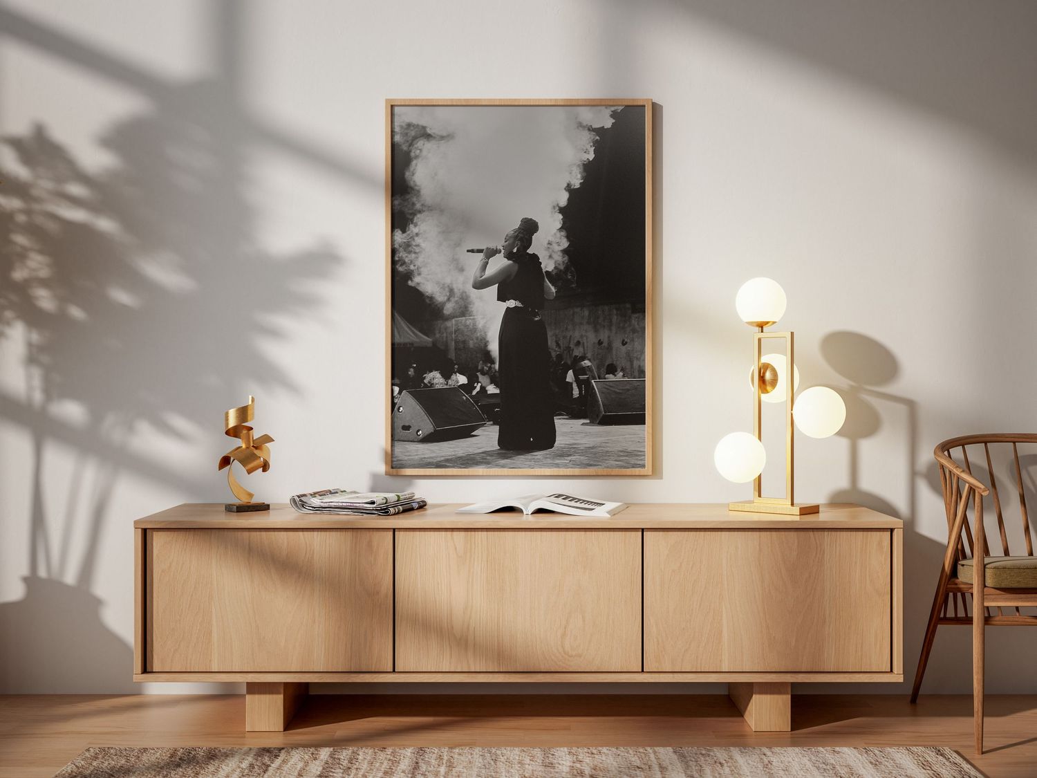 Black and white framed photo of a musician performing displayed above a wooden sideboard in a minimalist room.