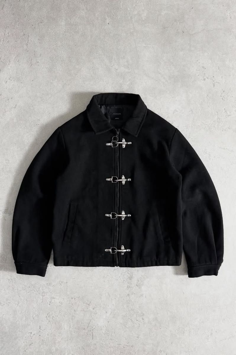Black wool jacket with silver toggle buckle closures and a spread collar, displayed flat on a gray background.
