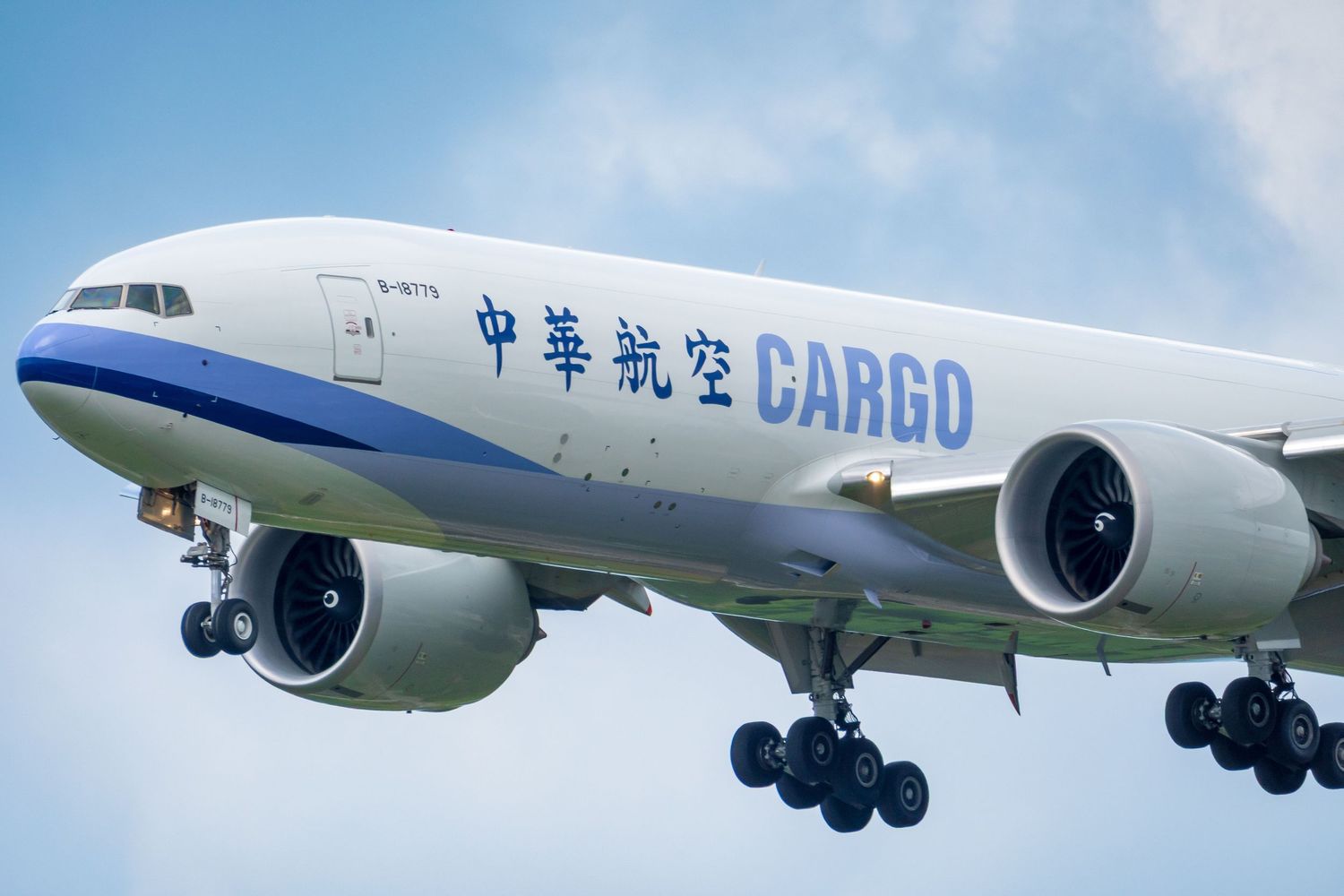 China Airlines Cargo Boeing 777 freighter aircraft in flight against a blue sky.