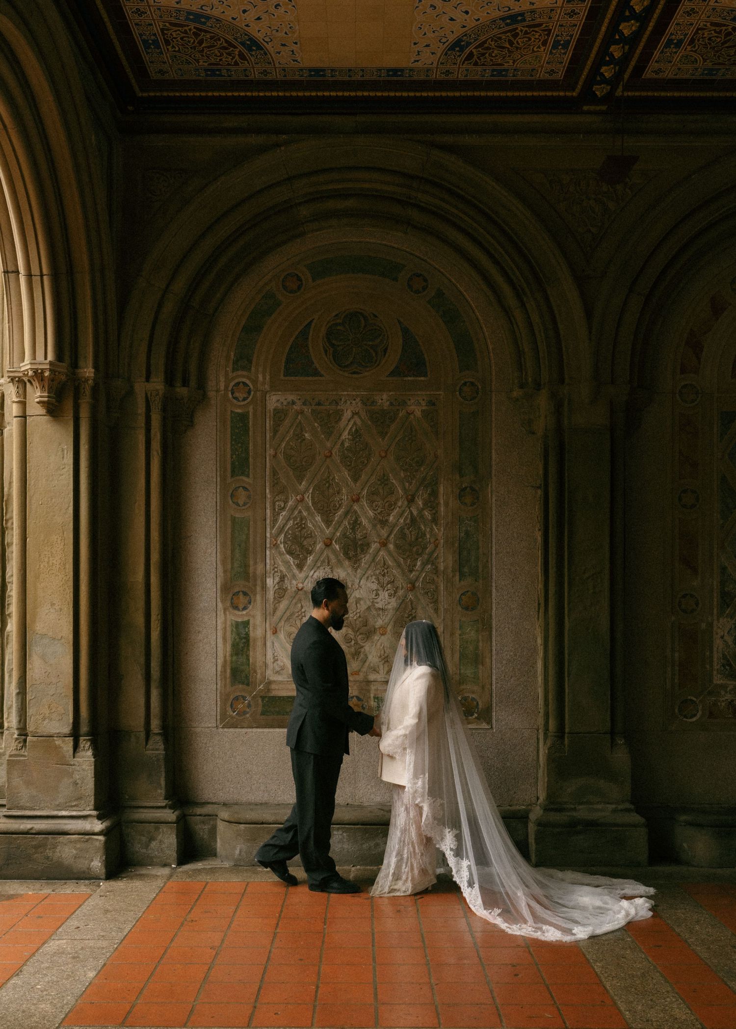 A bride and groom share a romantic moment in the ornate Bethesda Terrace arcade in Central Park, NYC.