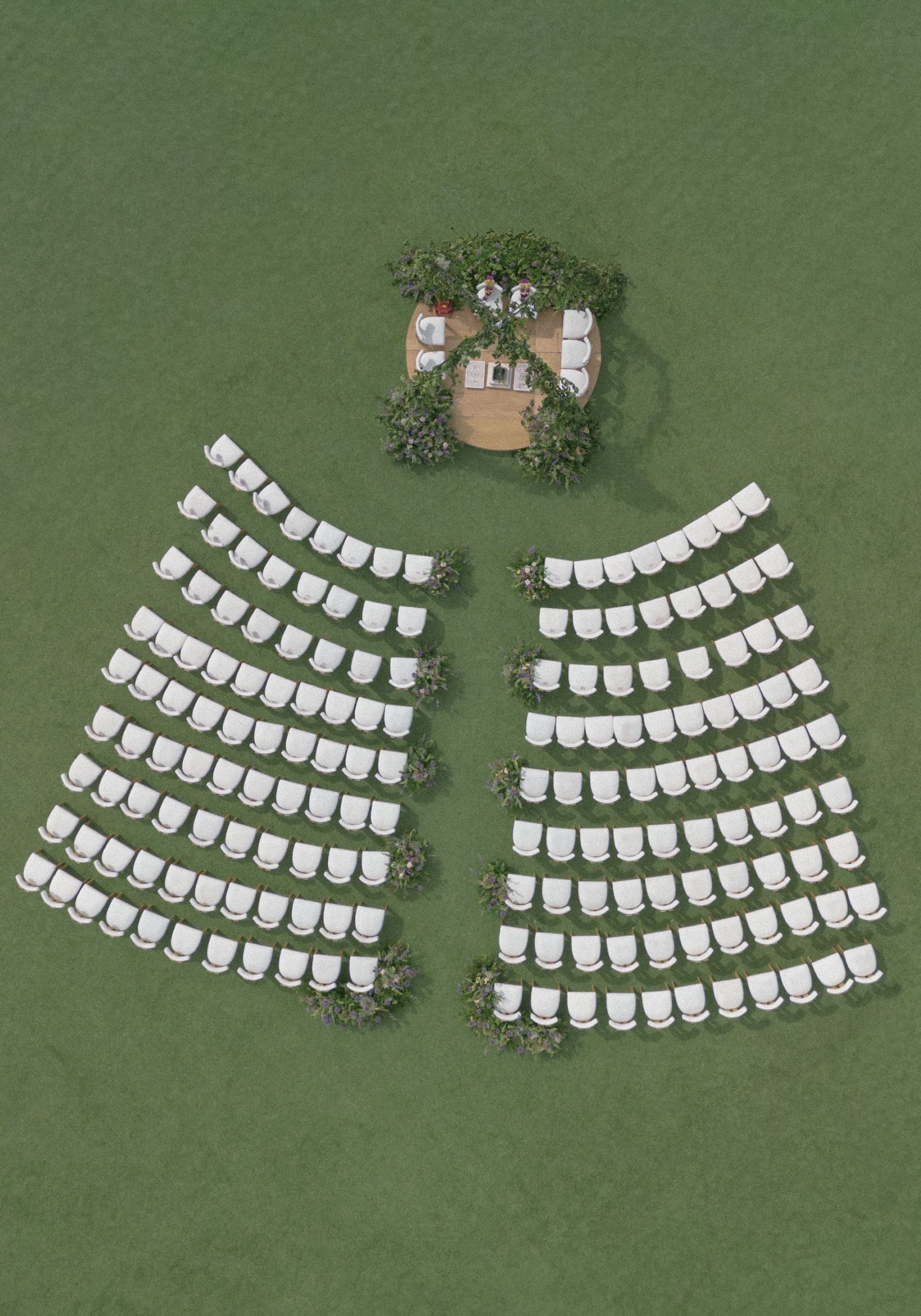 Aerial view of white chairs arranged in curved rows on green grass facing a small decorated outdoor ceremony altar.