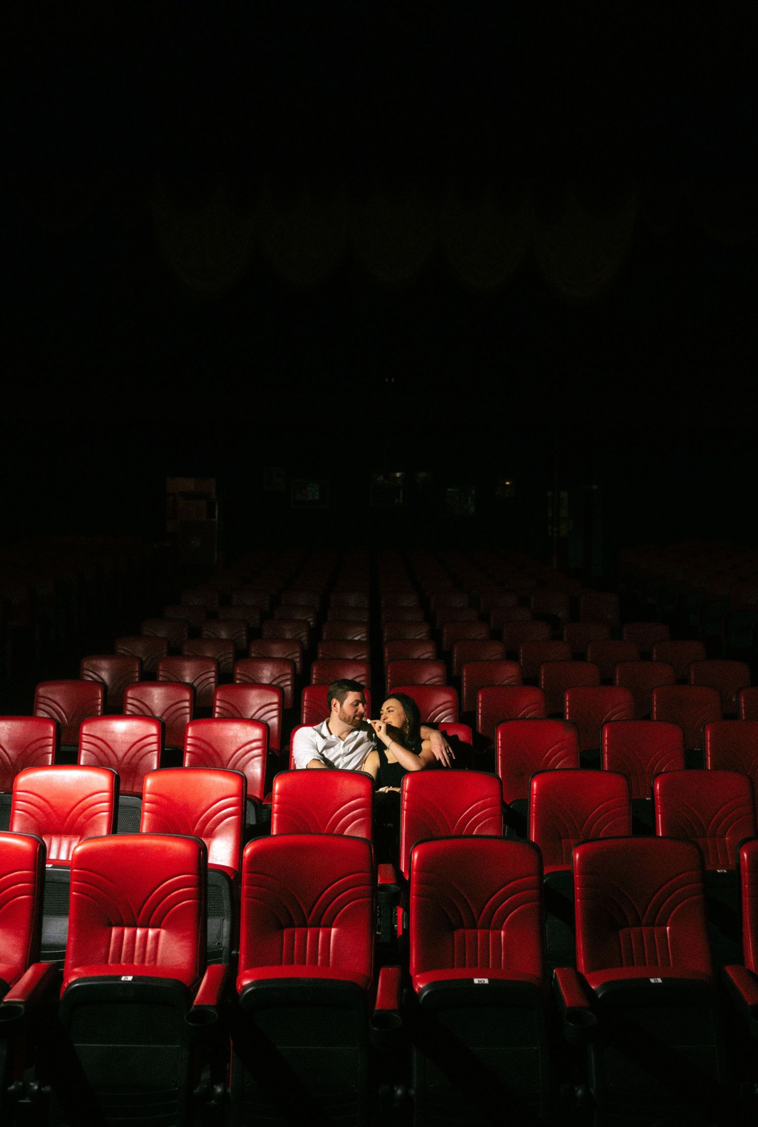 engagement photos at Plaza Theatre Atlanta marquee in the rain