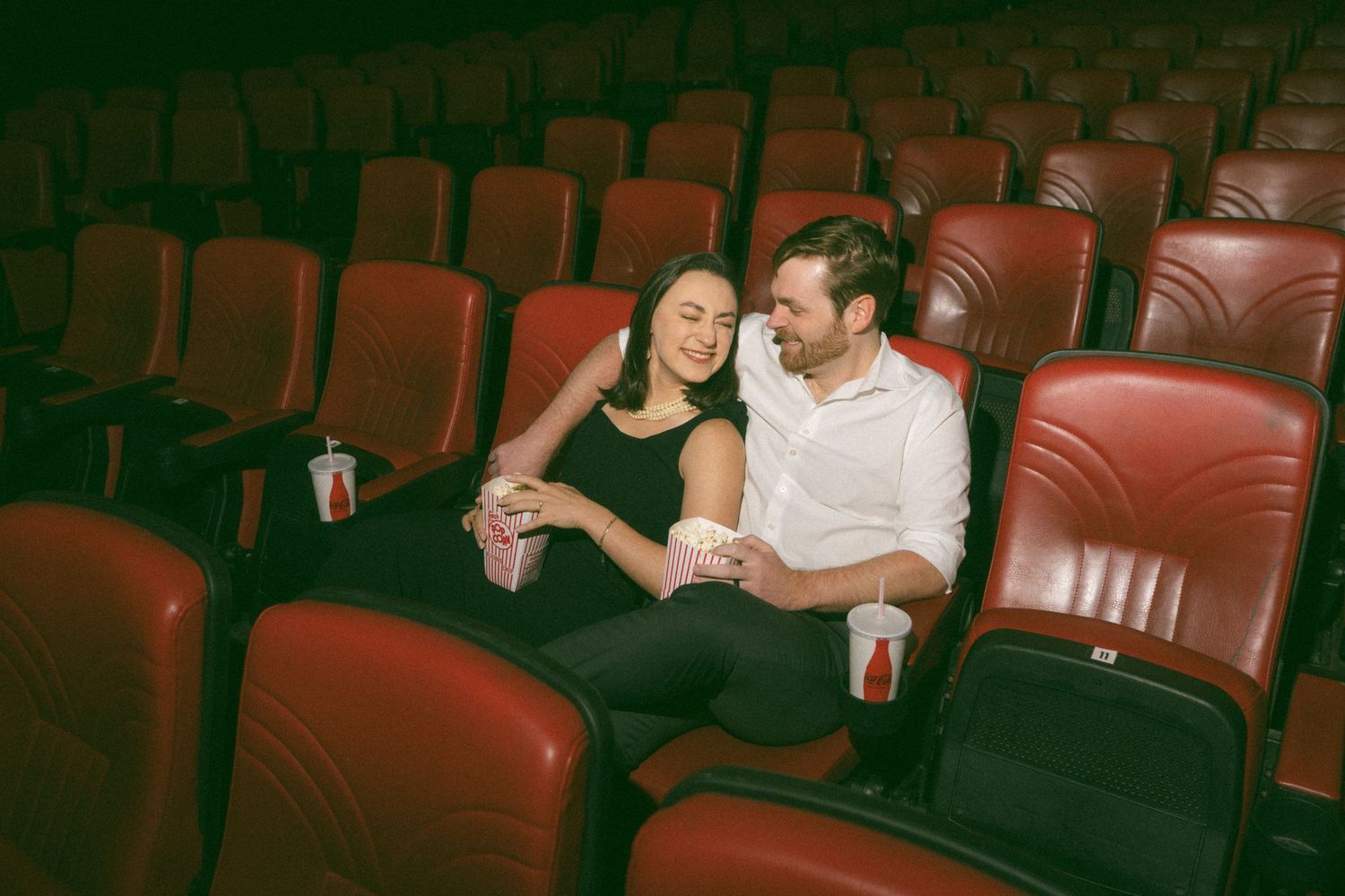 engagement photos at Plaza Theatre Atlanta marquee in the rain