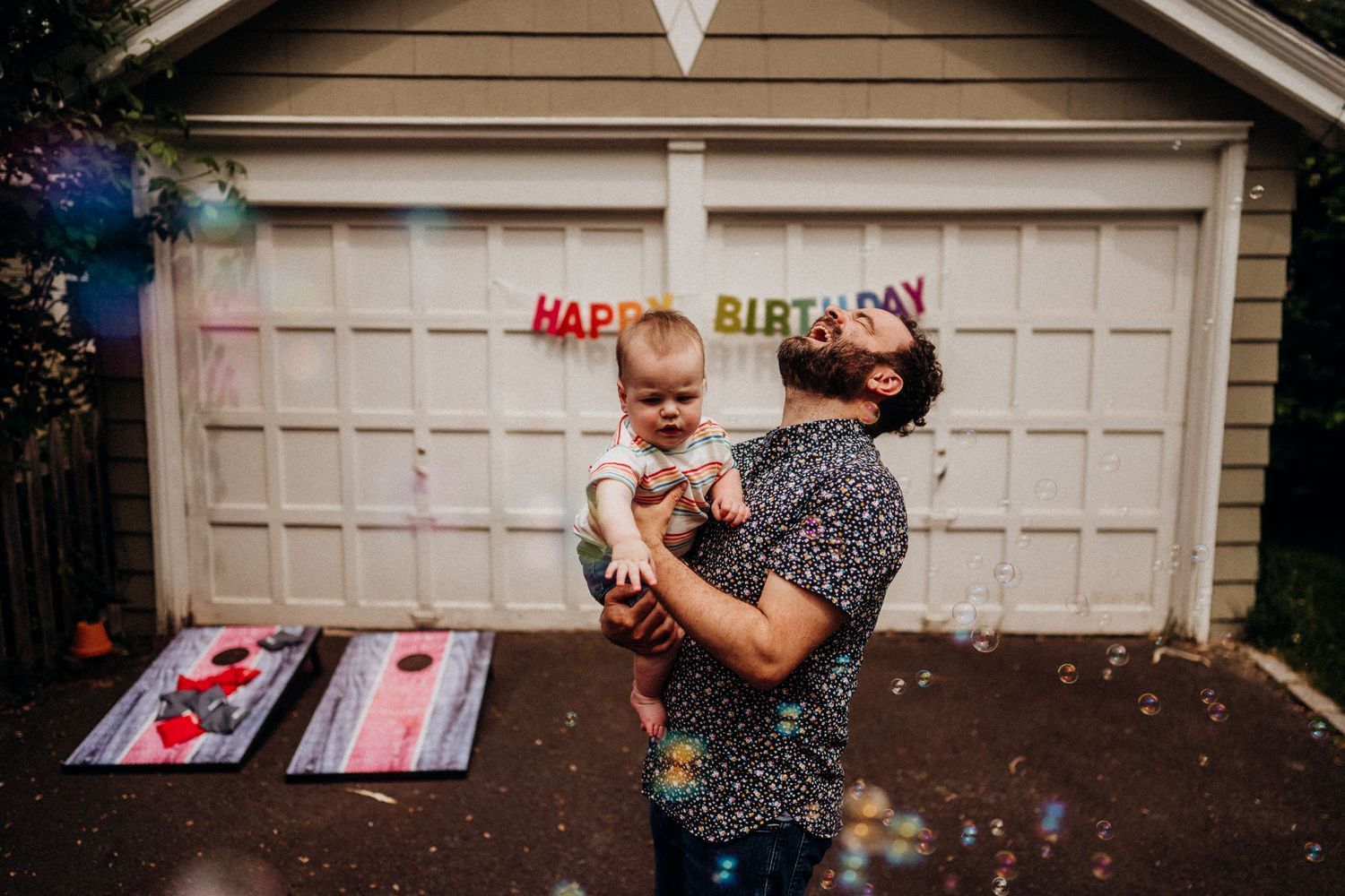 Birthday celebration with confetti flying in front of a garage door.