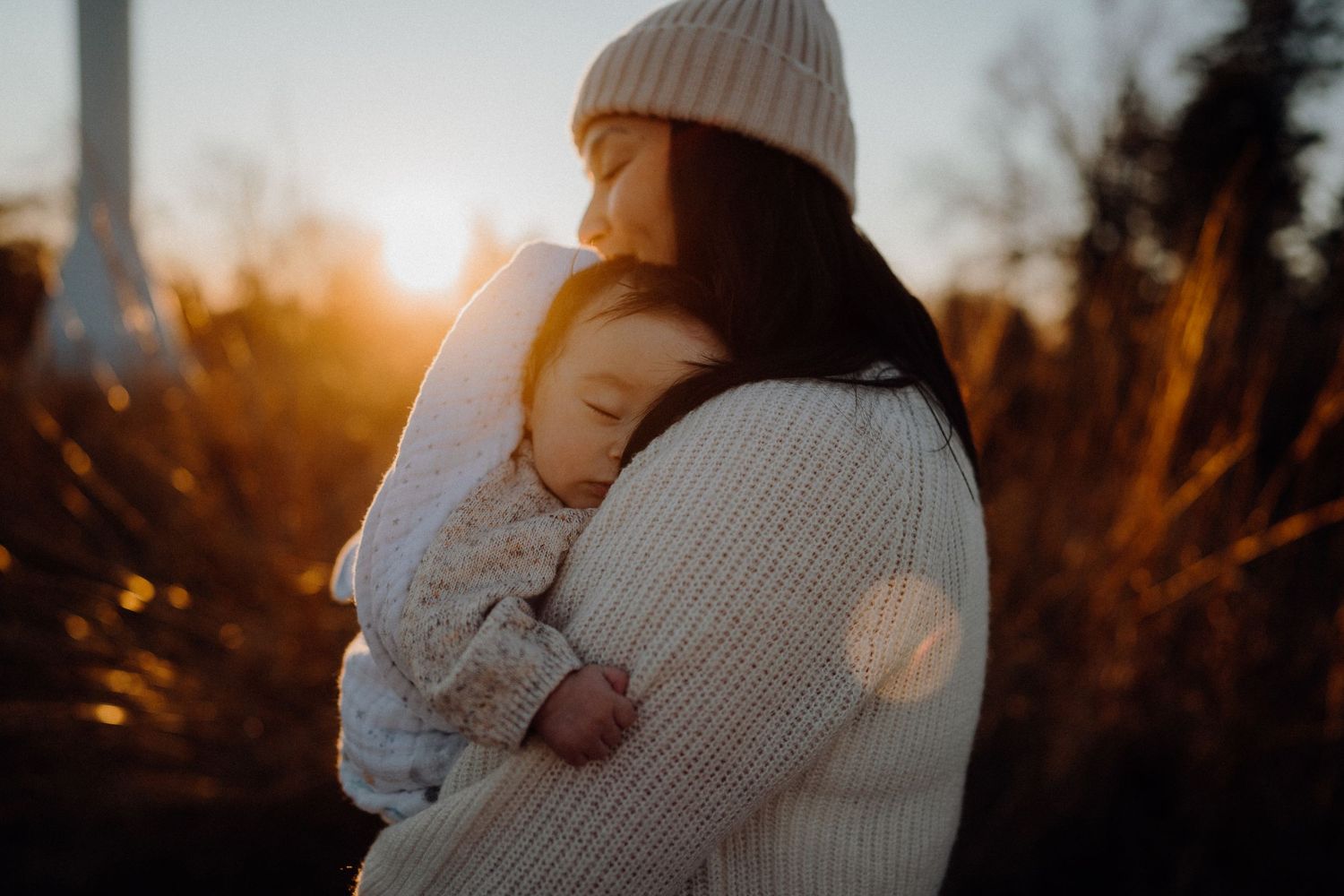 A tender embrace silhouetted against a warm sunset glow.