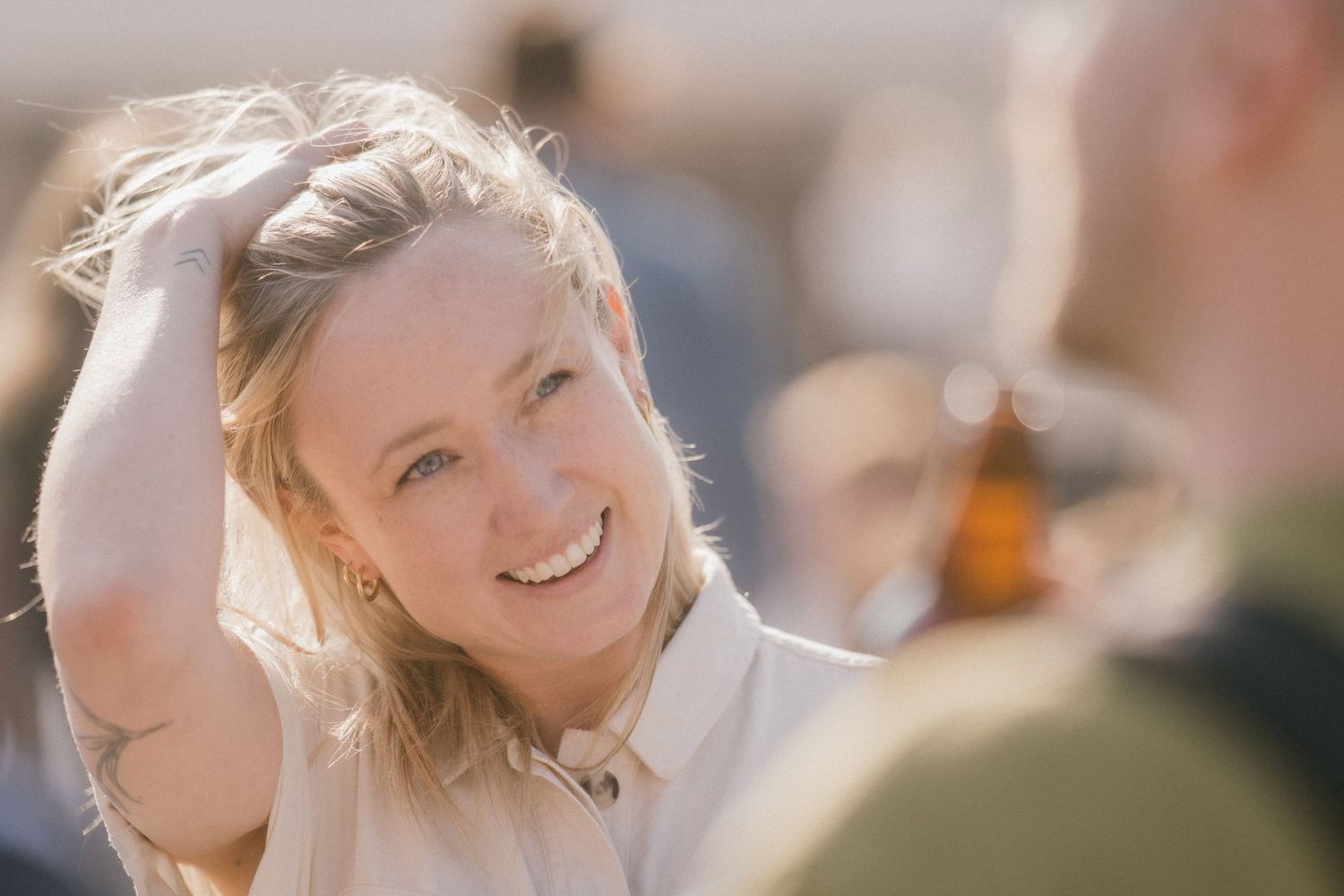 A joyful moment captured in warm sunlight at an outdoor gathering.