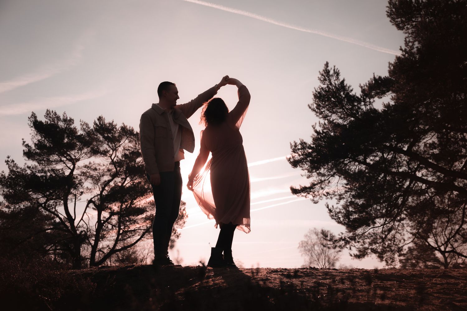 silhouetfoto van dansend koppel, fotoshoot waarbij spontane momenten voorrang hebben