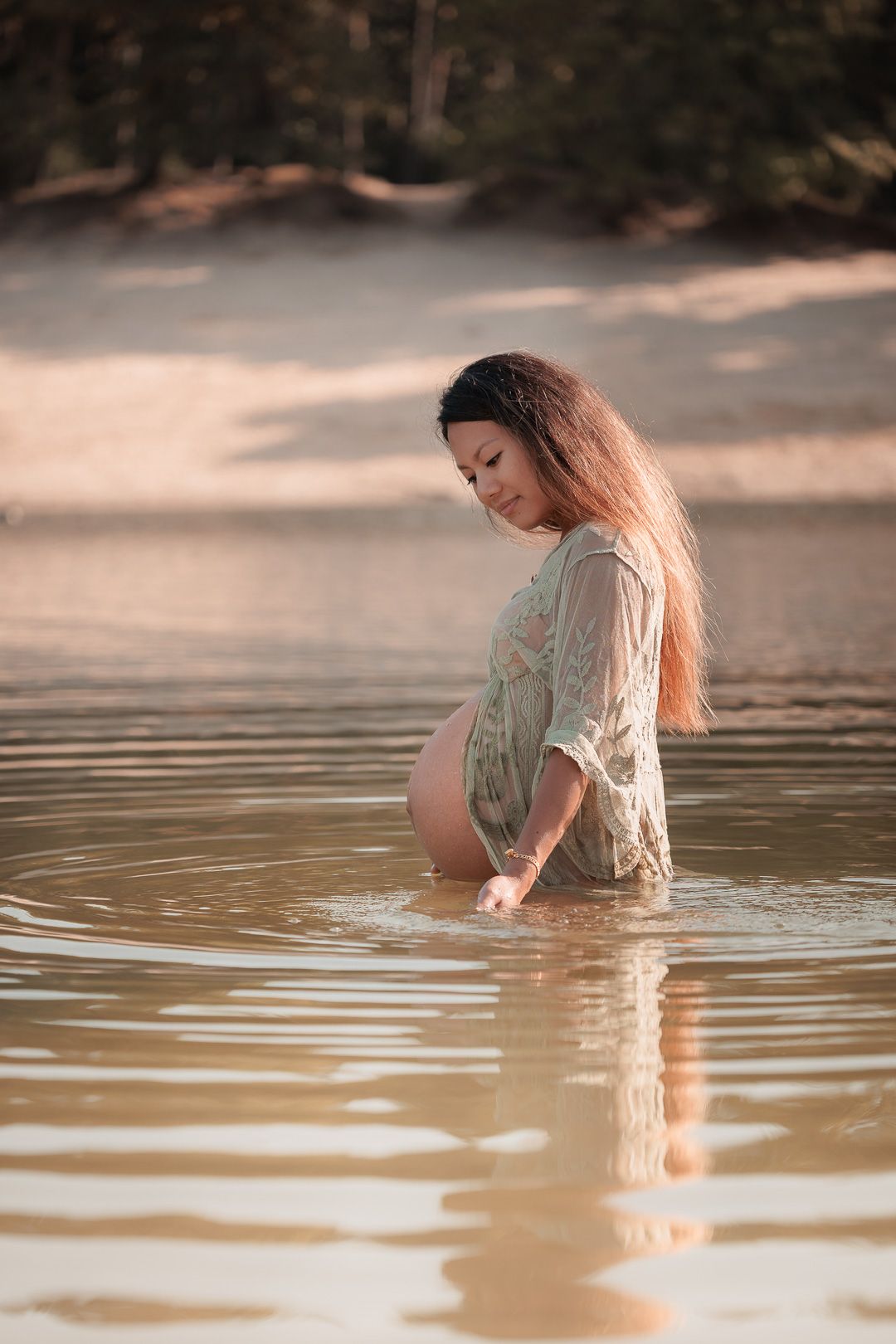 Zwangere vrouw met blote buik in het water tijdens intiem moment in West-Brabant