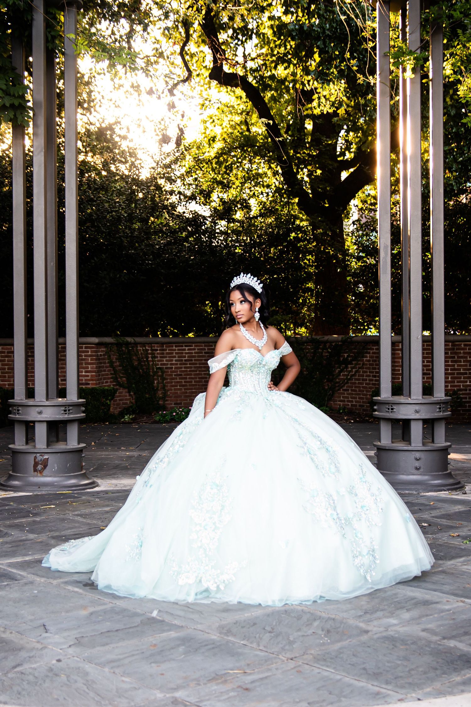Ethereal white ball gown captured in elegant columned outdoor venue.