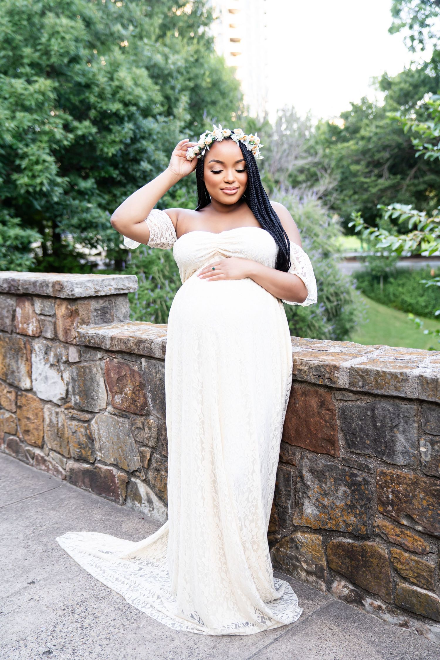 Elegant bridal portraits showcasing a flowing white lace gown against a rustic stone wall setting.