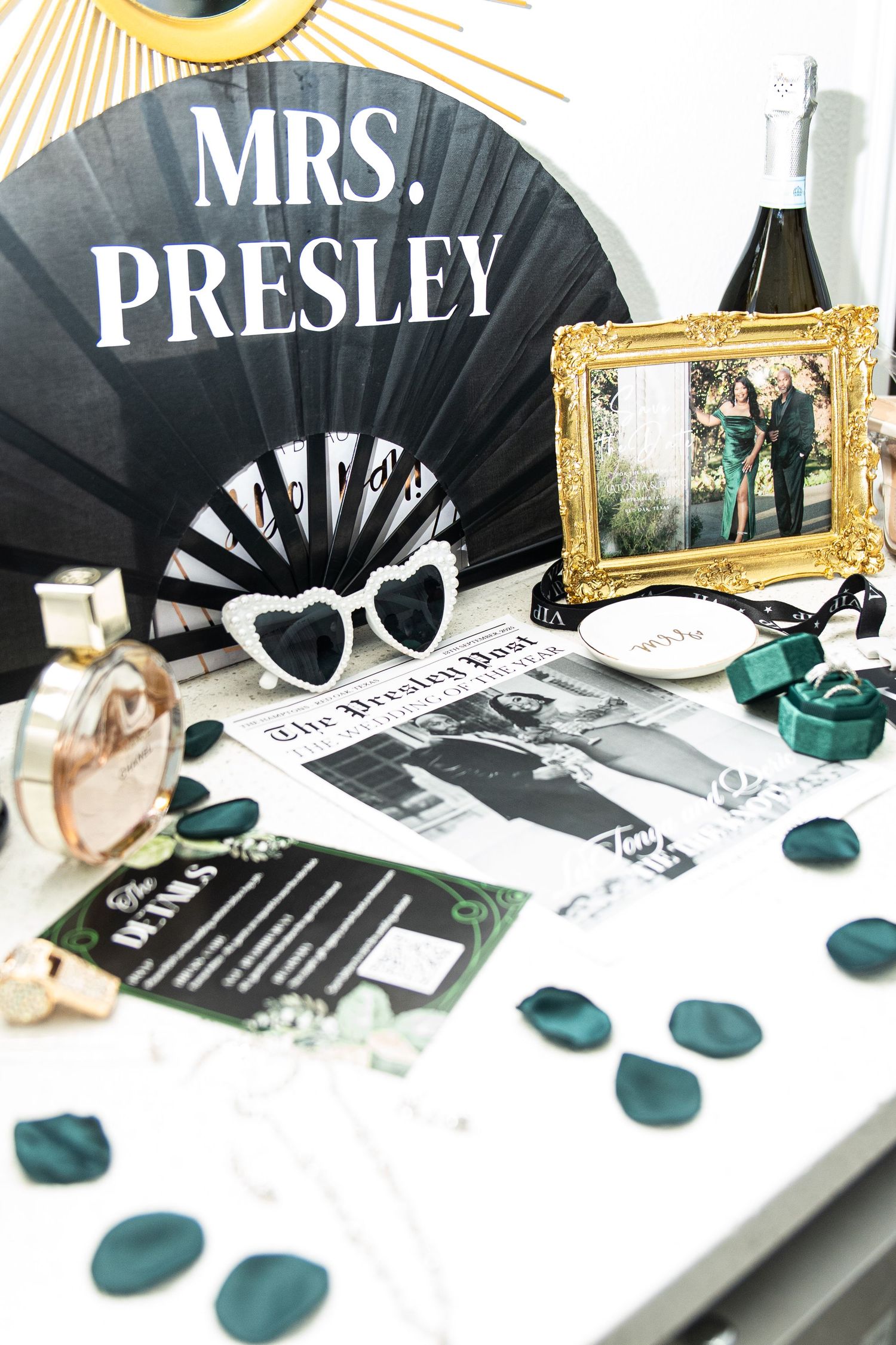 Wedding reception table decor with gold frames, teal accents, and personalized name cards.