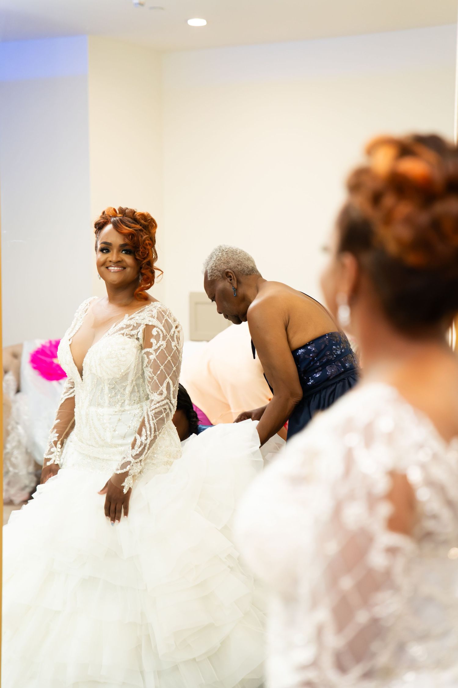 Wedding celebration scene with guests in white dresses gathering together.