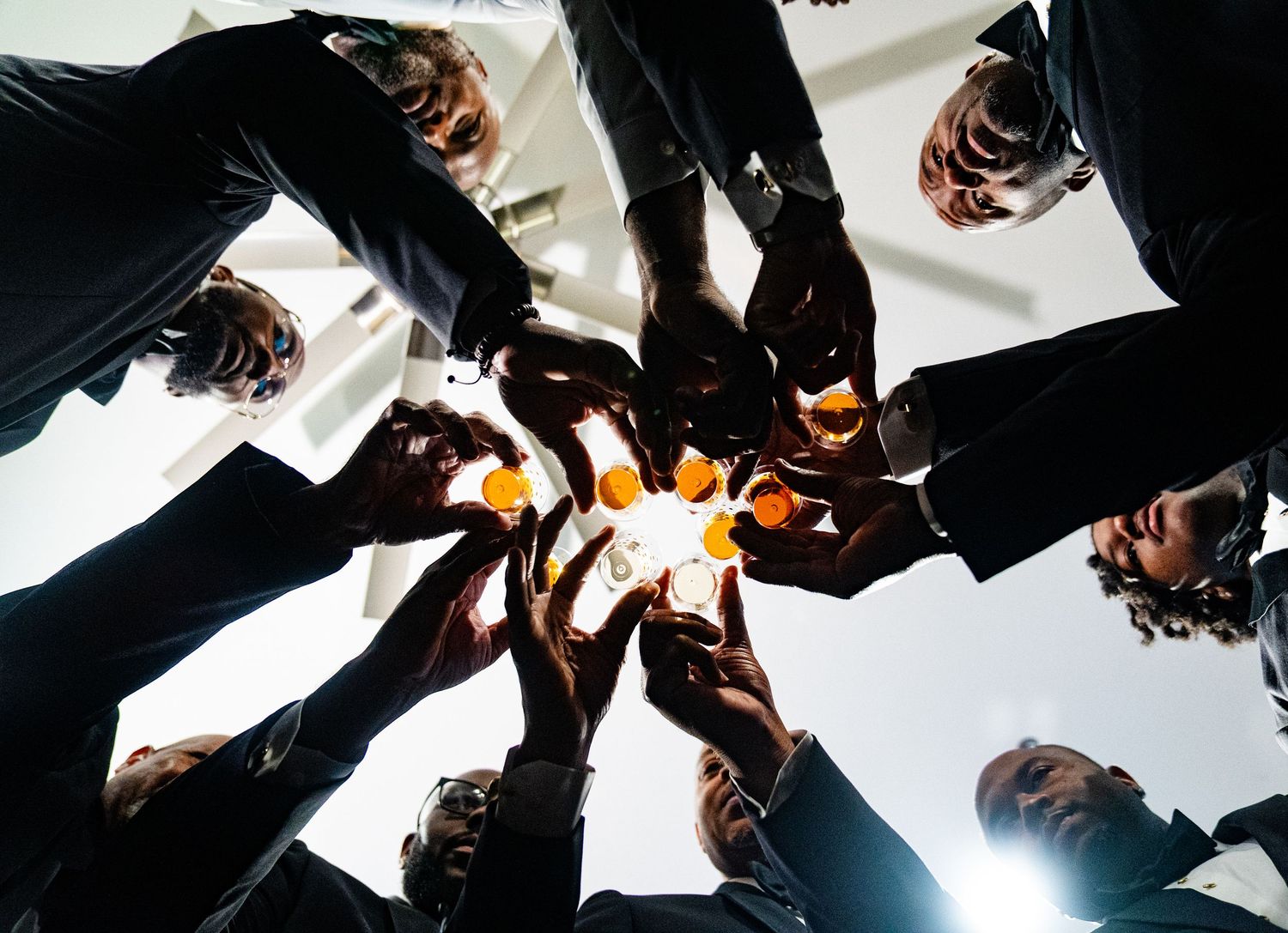 Creative low-angle shot of groomsmen in formal attire.
