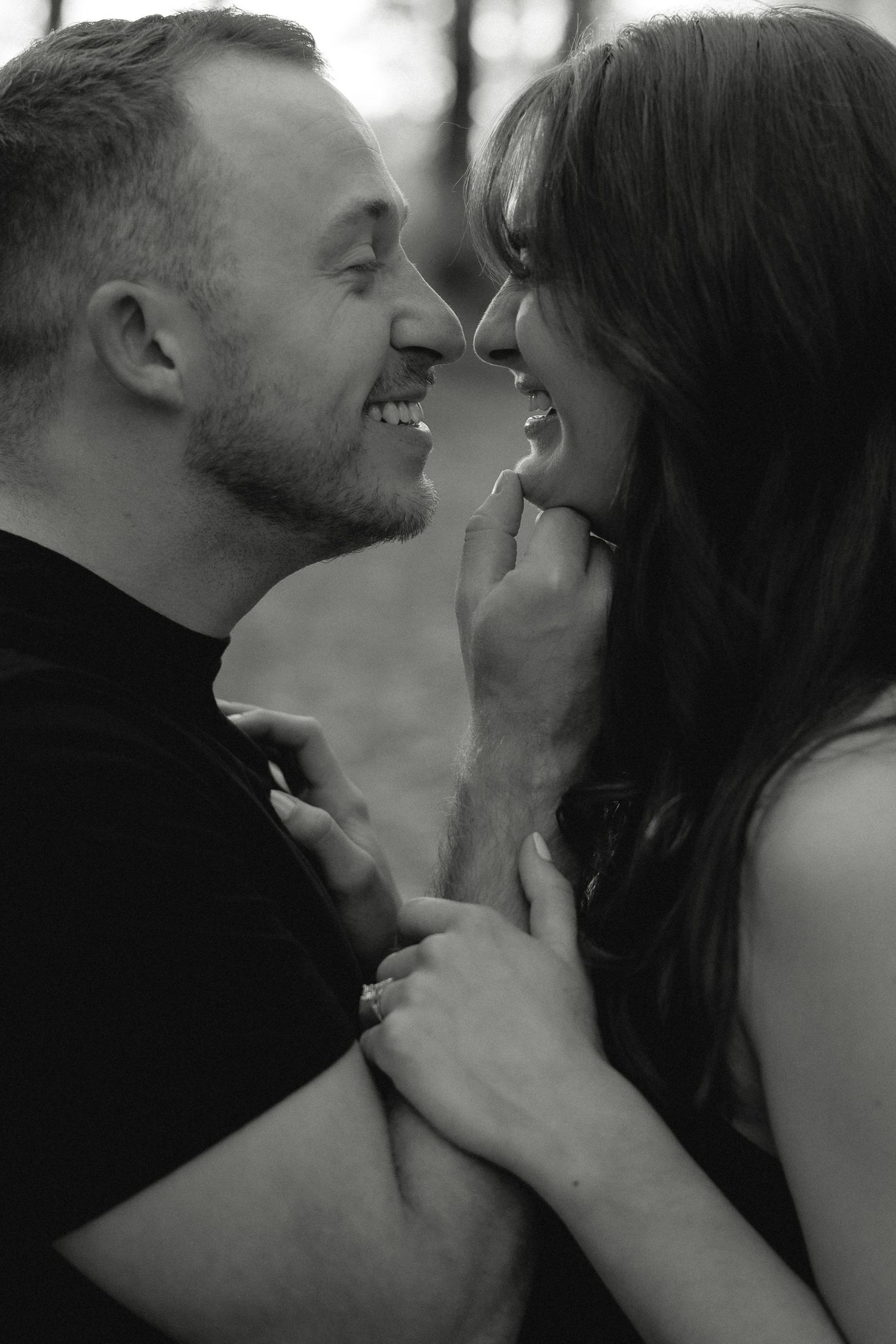 An intimate black and white portrait series showing tender moments between a couple.