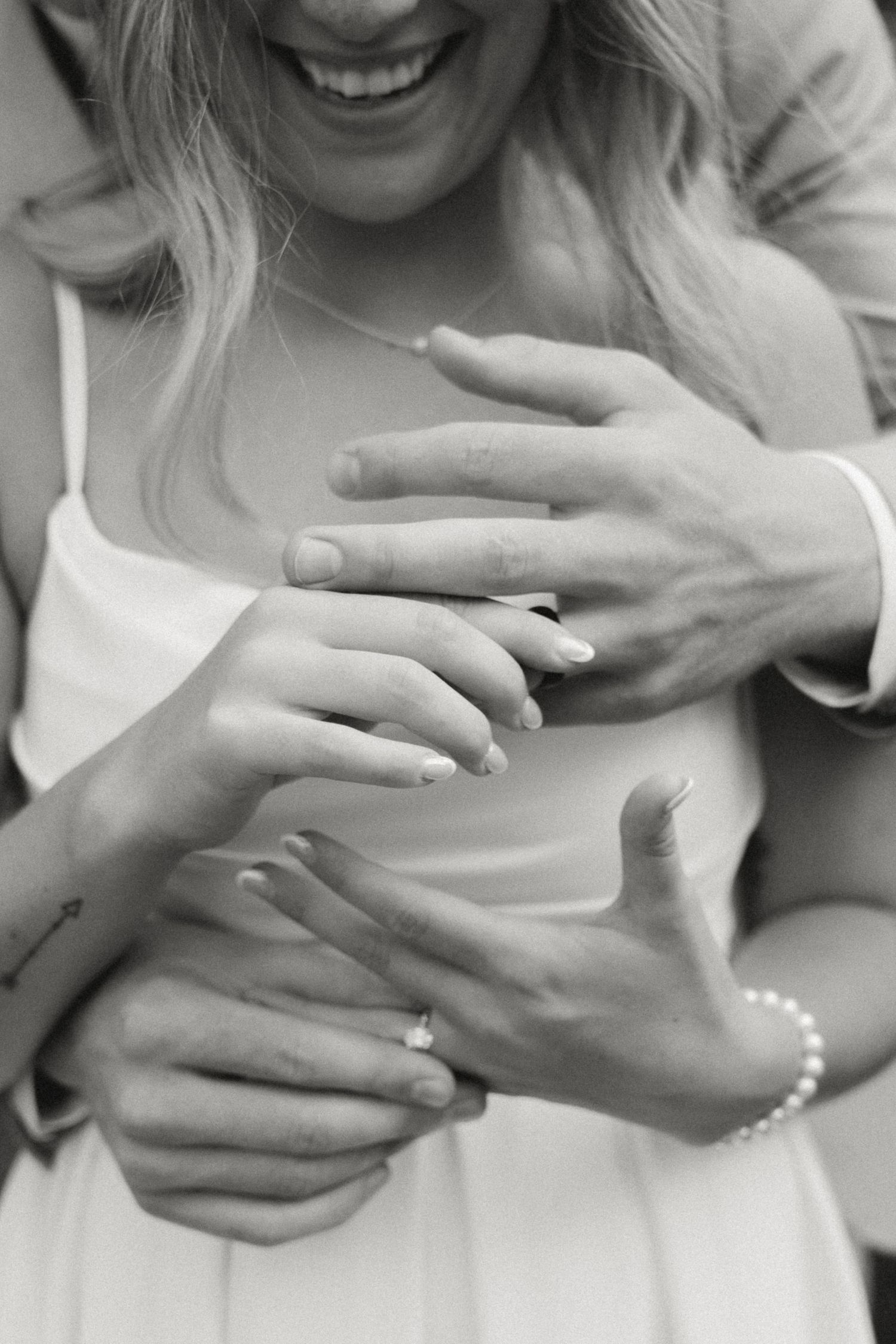 Black and white photo series showing hands holding and interacting with a small object in sequence.