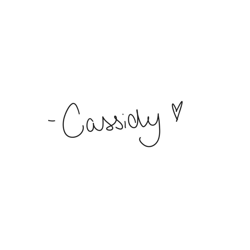 A handwritten signature in black ink with a heart symbol on a white background.