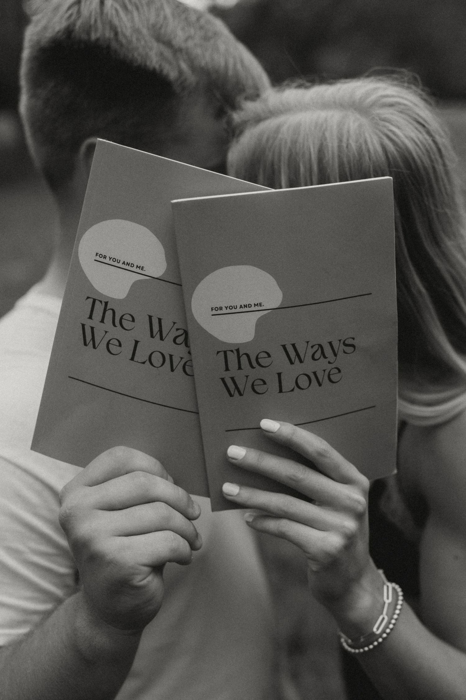 Black and white sequence showing hands holding and reading a book titled 'The Wars We Love'.