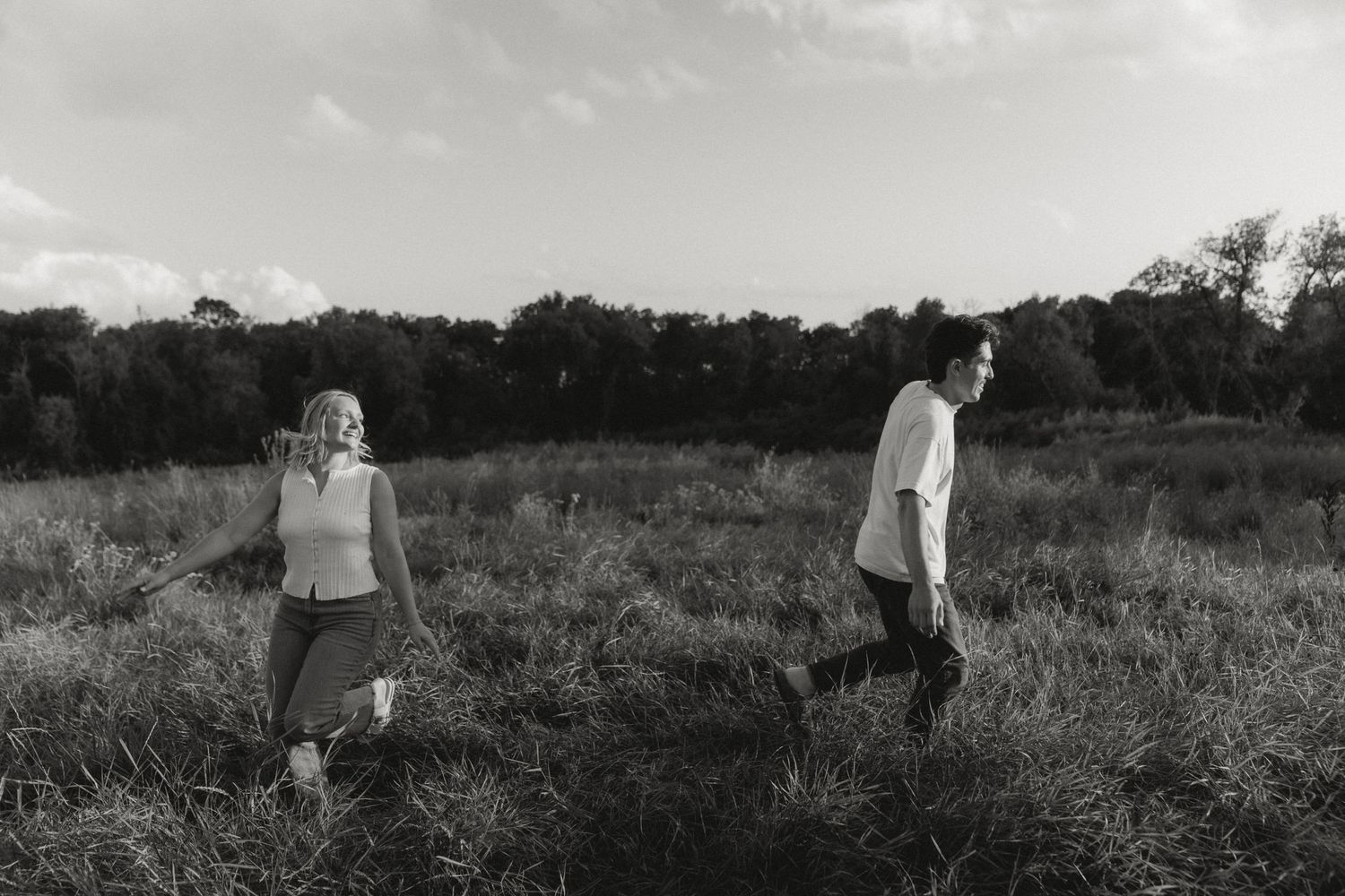A romantic black and white portrait session in a rustic field setting.