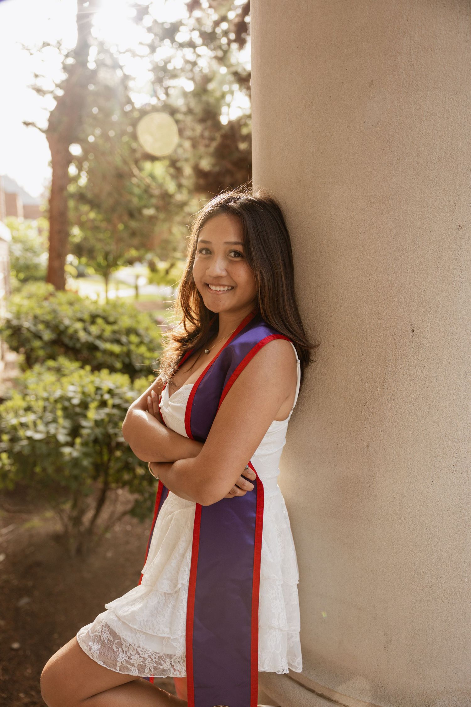 A series of four portraits showing a person in a white lace dress and navy blue and red sash against a light background.