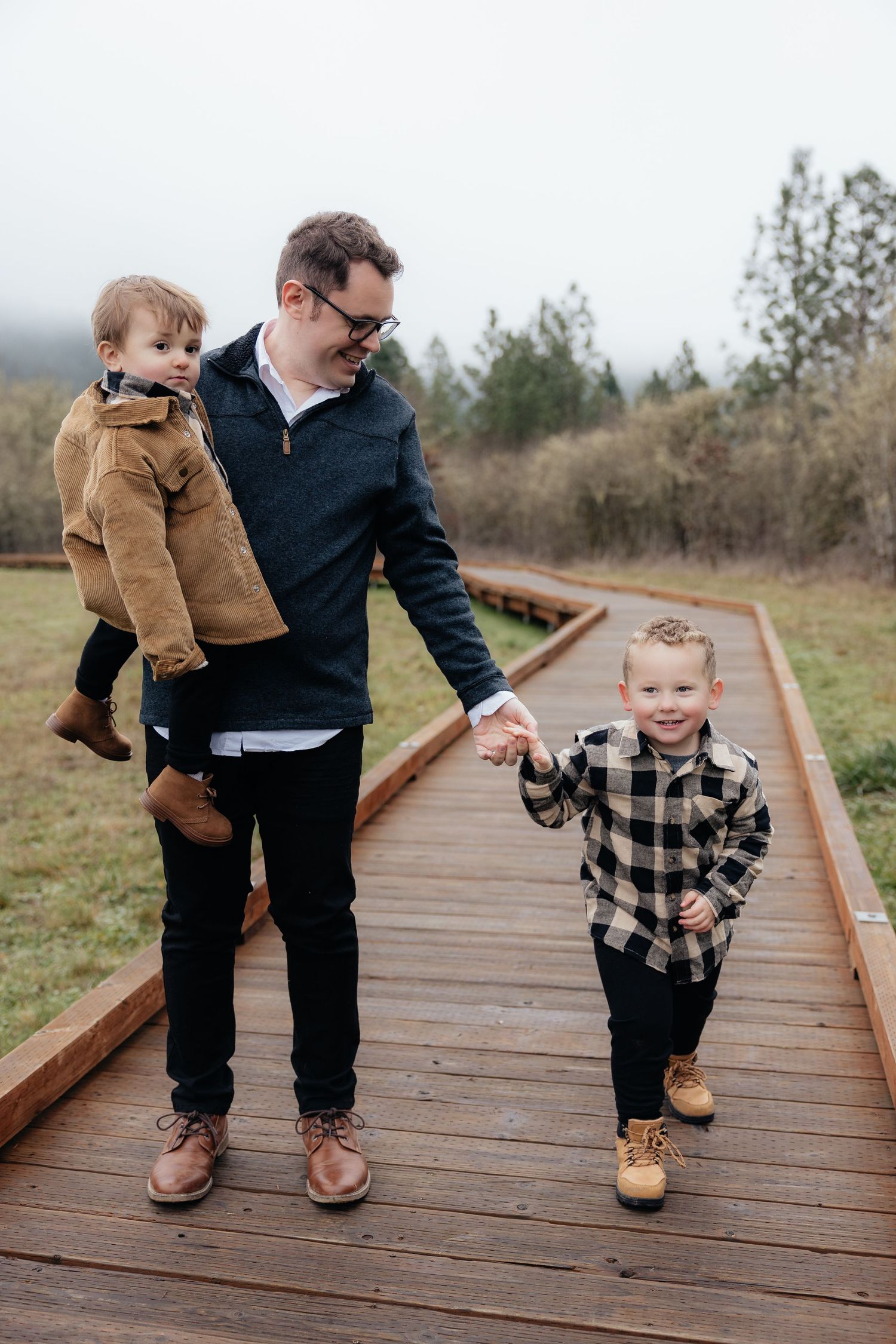A parent and child walk along a wooden boardwalk through a natural area, shown in a series of connected photos.