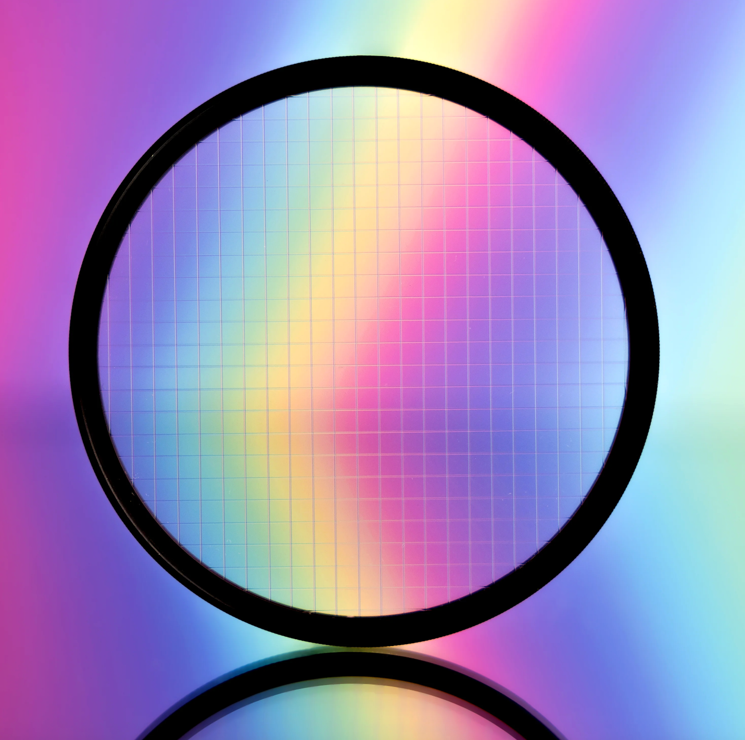 Circular optical filter with vibrant rainbow diffraction pattern on reflective surface with colorful gradient background.