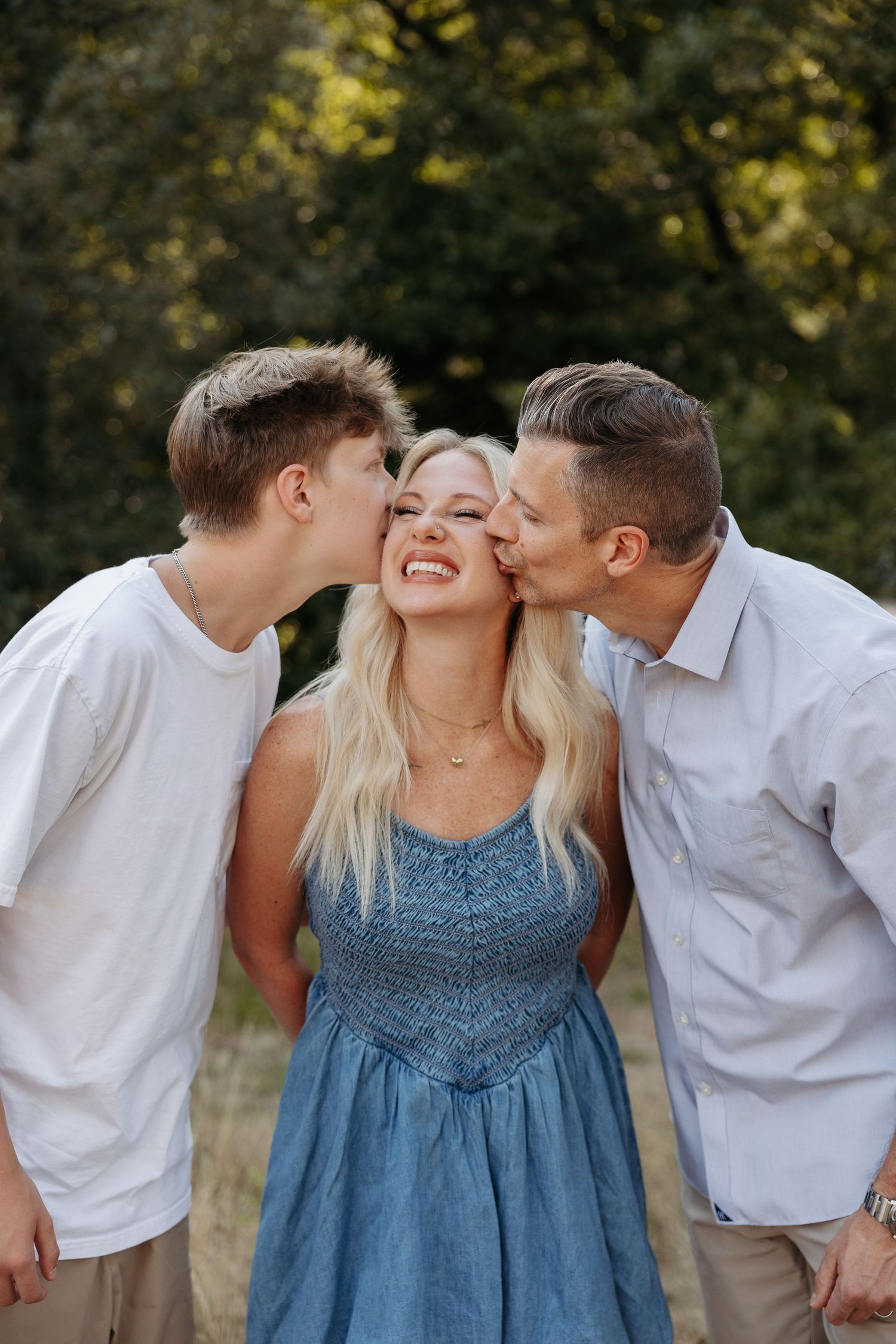 A series of candid photos showing a family sharing sweet moments and kisses in a natural outdoor setting.