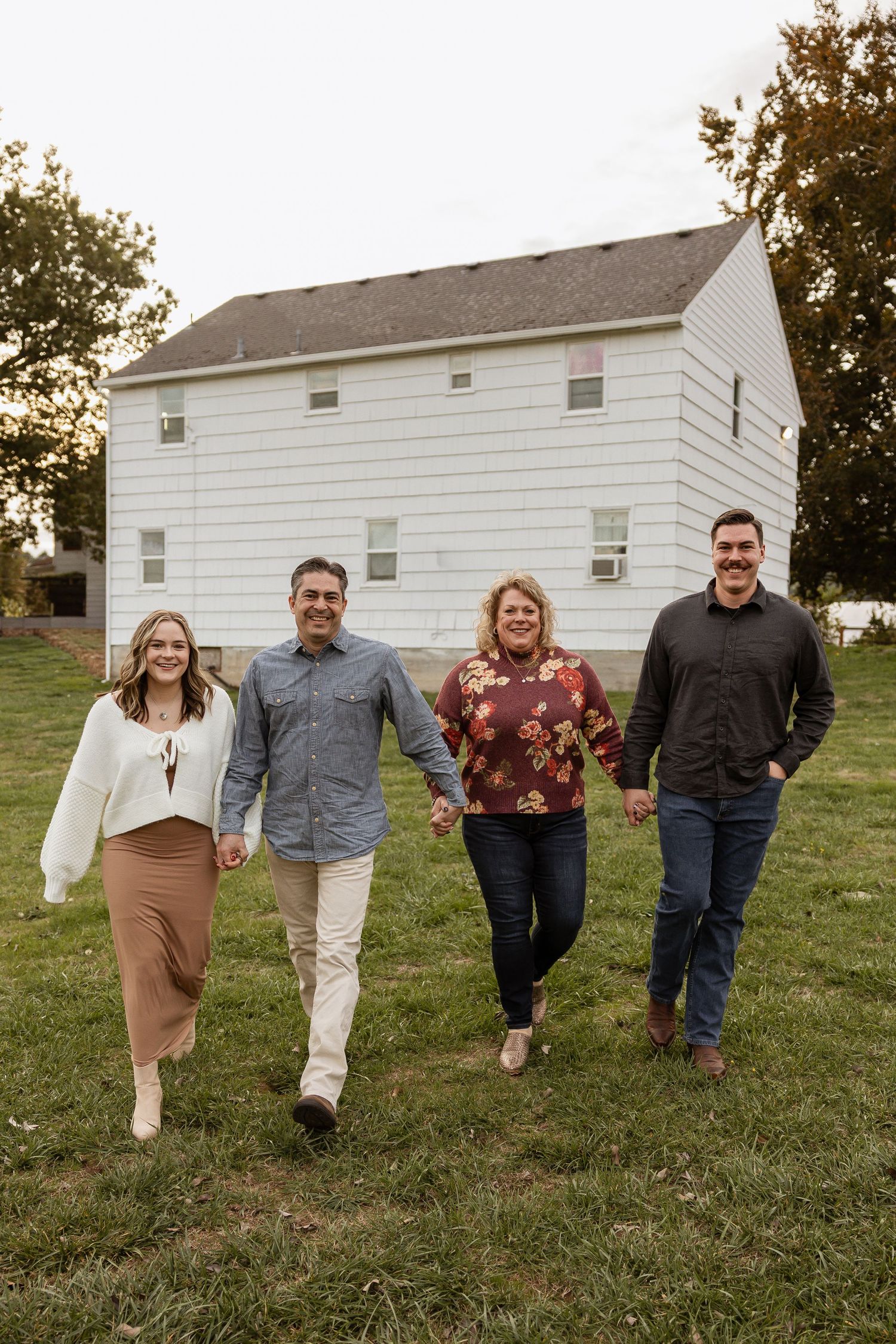 A series of photos showing people walking together on a grassy hill with a white building in the background.