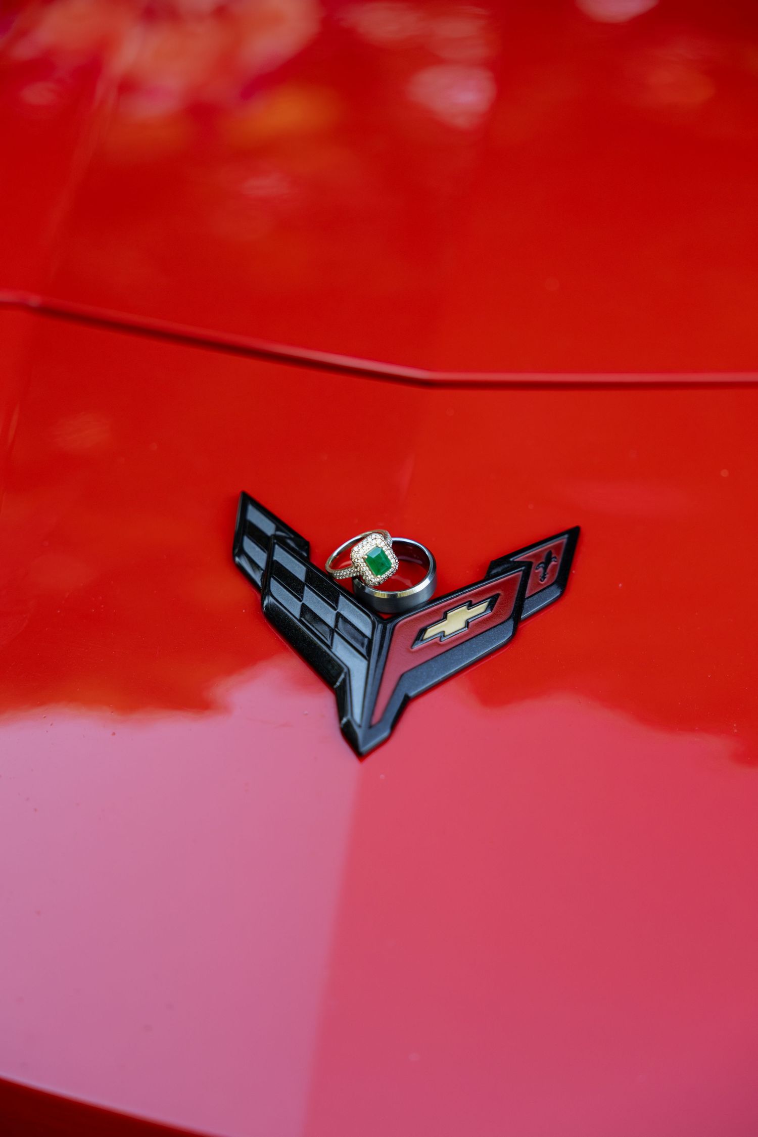 A series of close-up shots showing a red car's hood ornament emblem against a vibrant red background.