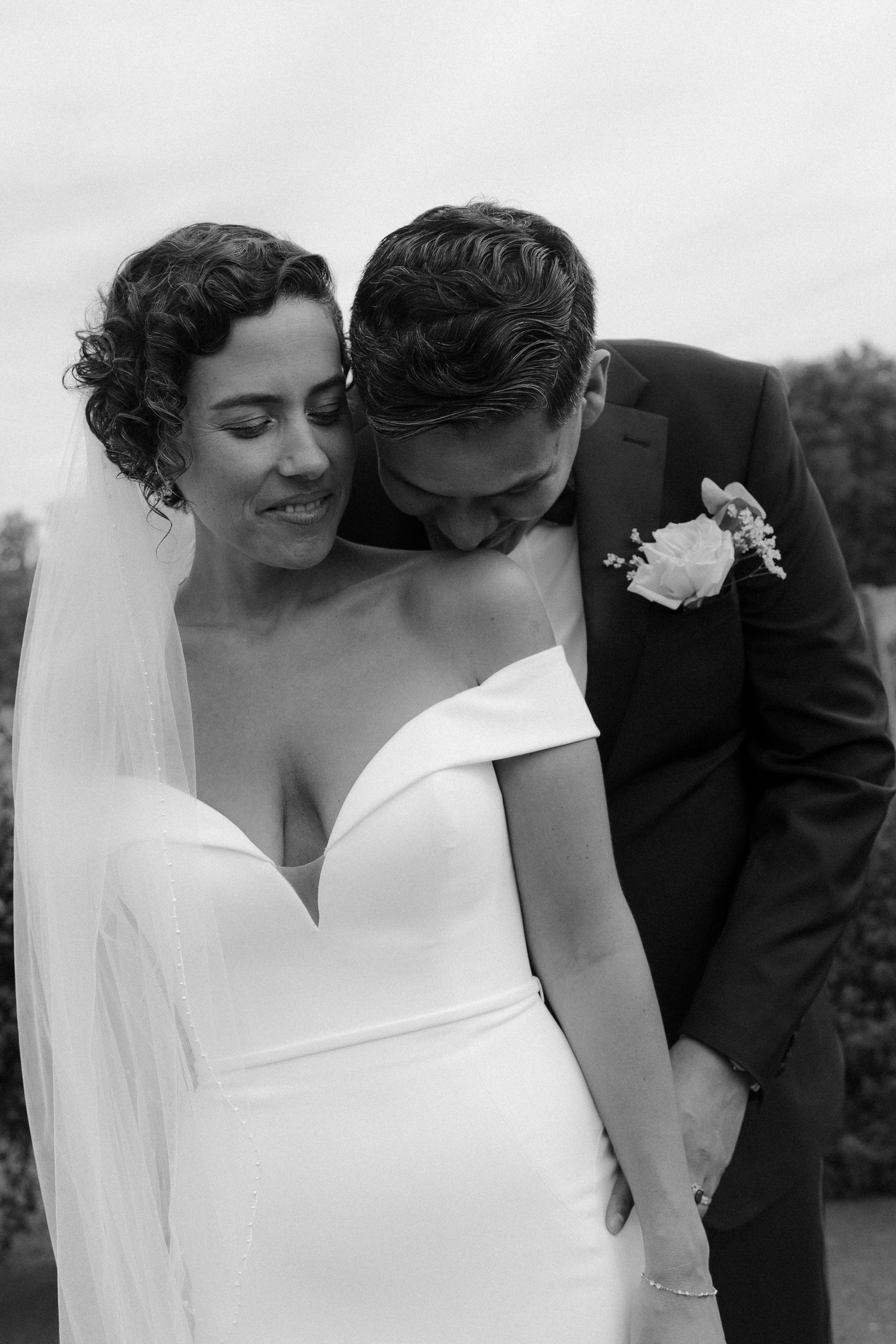 Black and white wedding photos showing intimate moments between newlyweds in a romantic sequence.