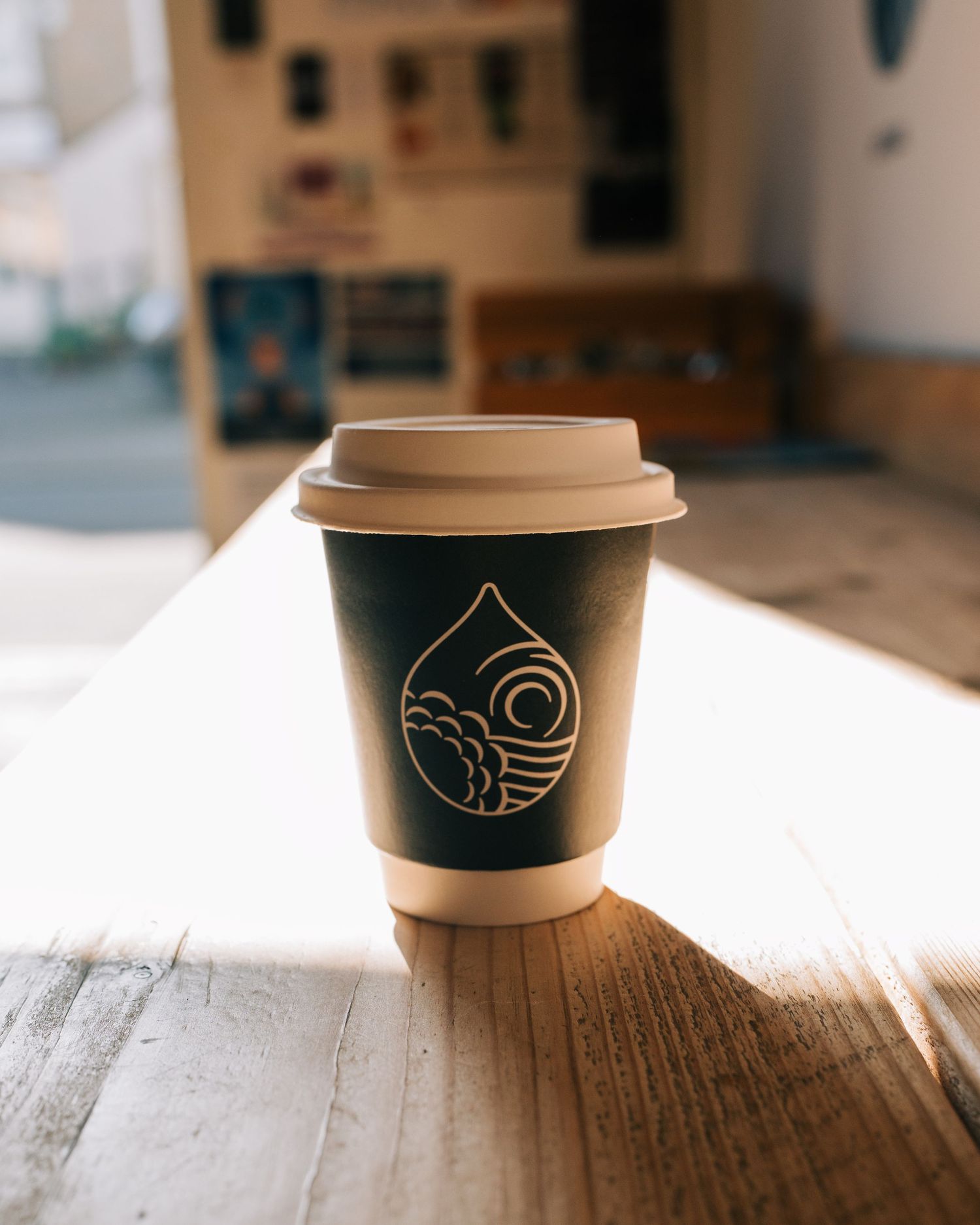 take away coffee sitting on a cafe bar counter in the sun for lifestyle photography stockholm