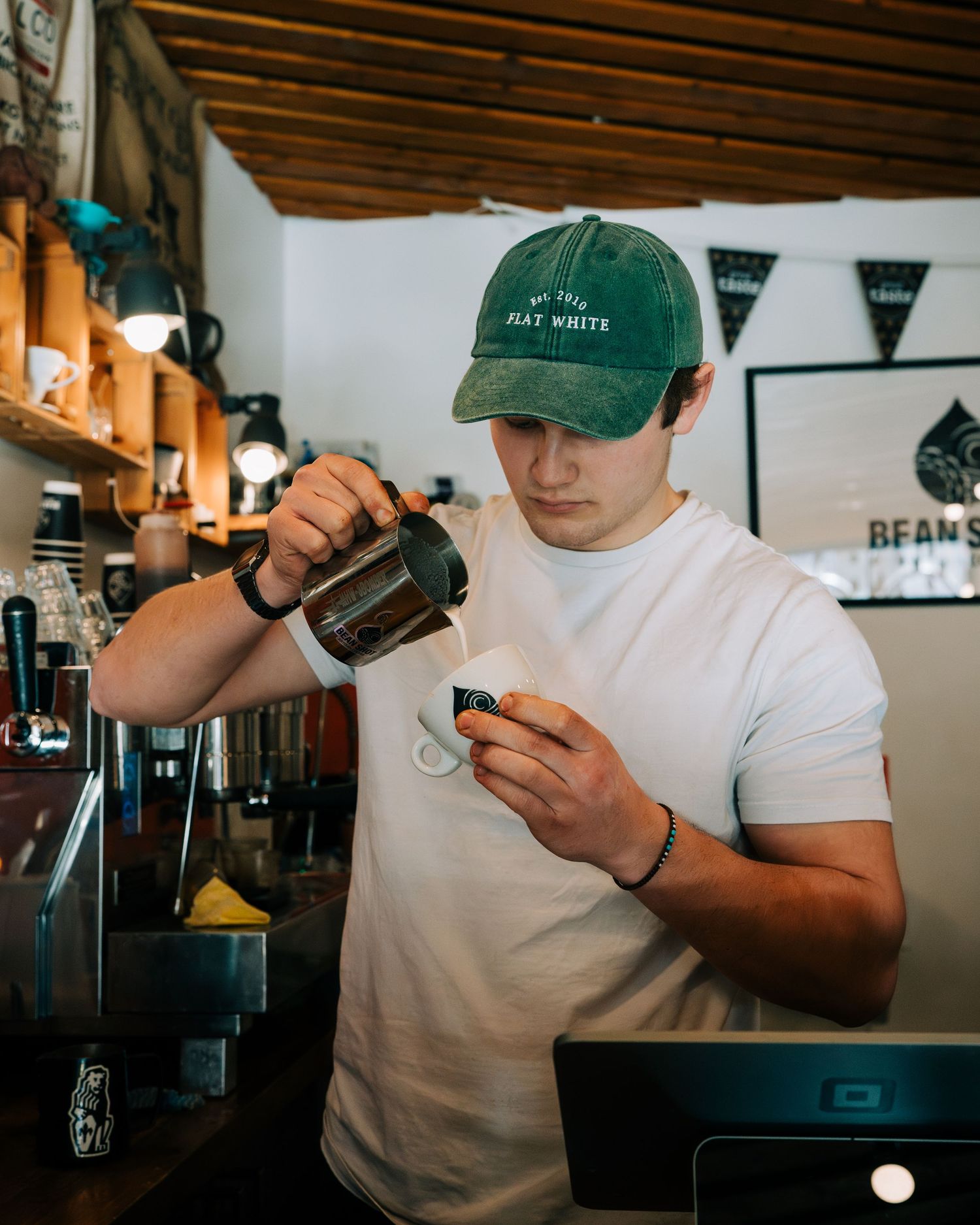 barista pouring coffee in a cafe for lifestyle photography in Stockholm for restaurants