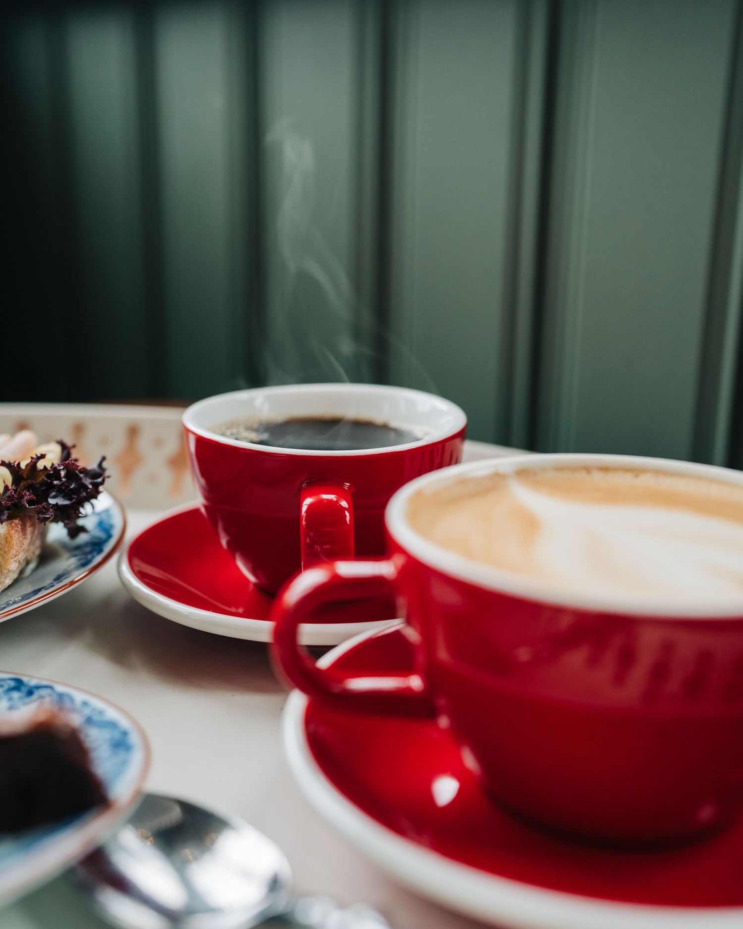 steaming hot cup of coffee on a table in a cafe in Stockholm Sweden for food photography mat fotografering